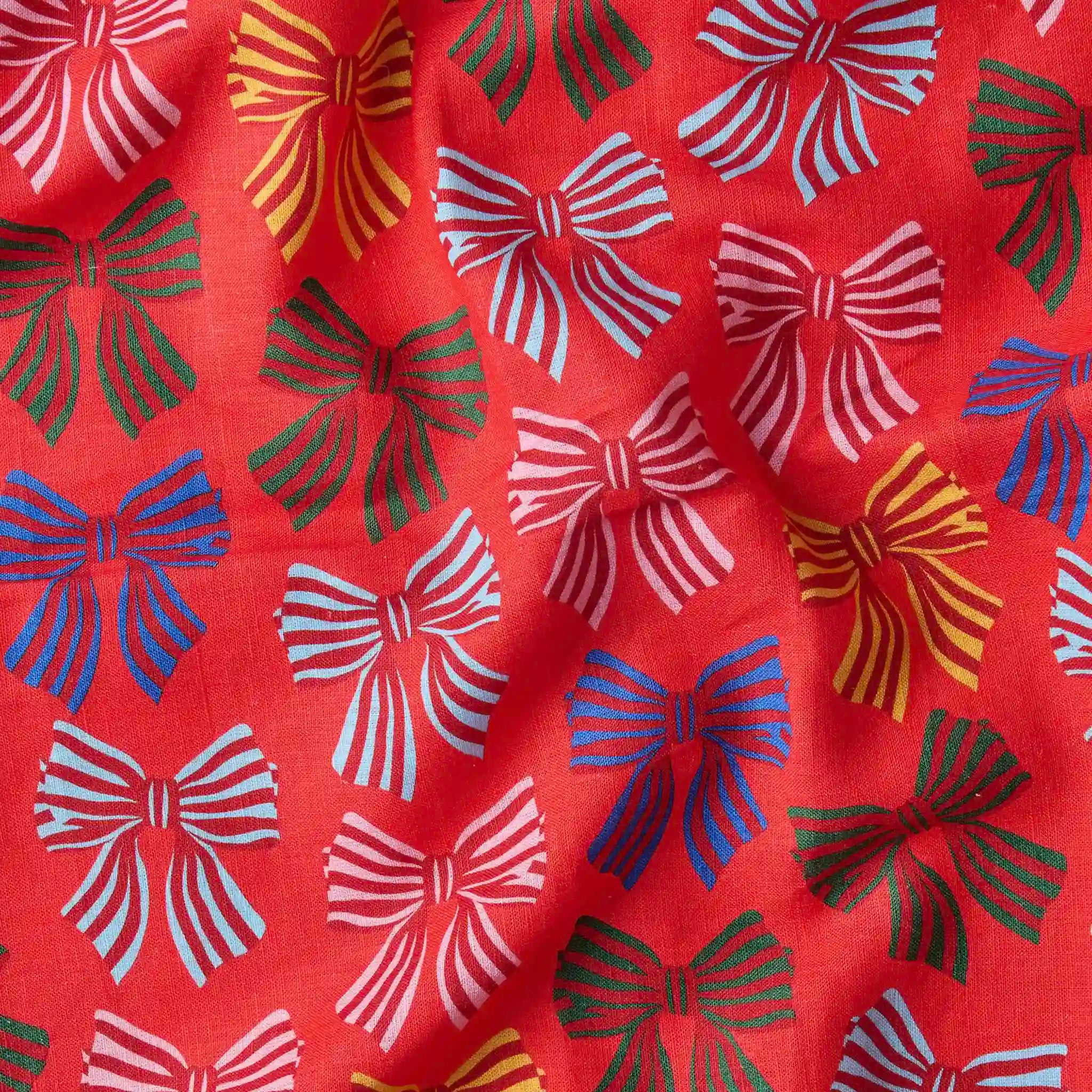 Red fabric with colorful bow pattern