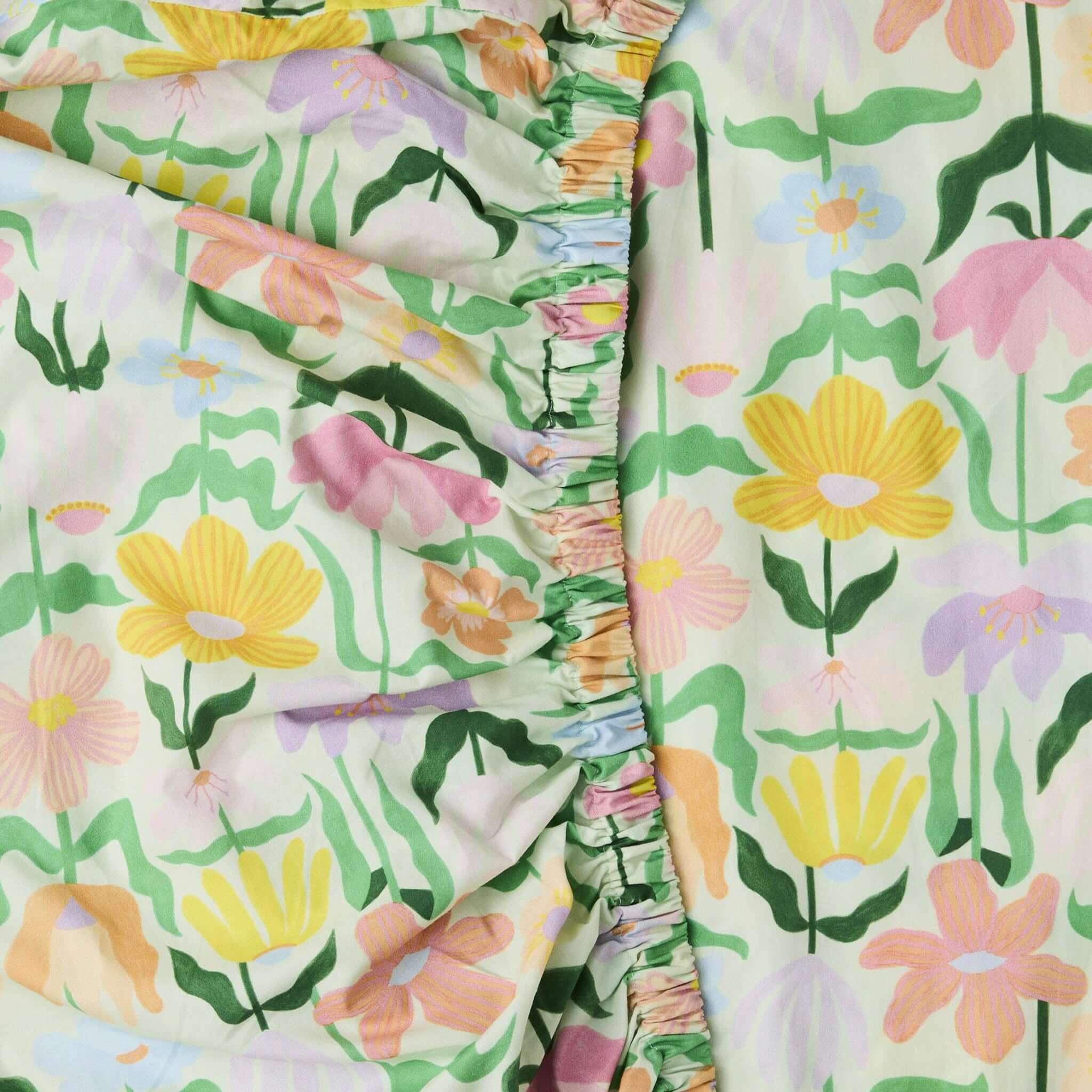 Alt Tag: Kip & Co Organic Cotton Baby Fitted Cot Sheet - Popping Flowers Green pastel floral print GOTS organic cotton nursery sheet