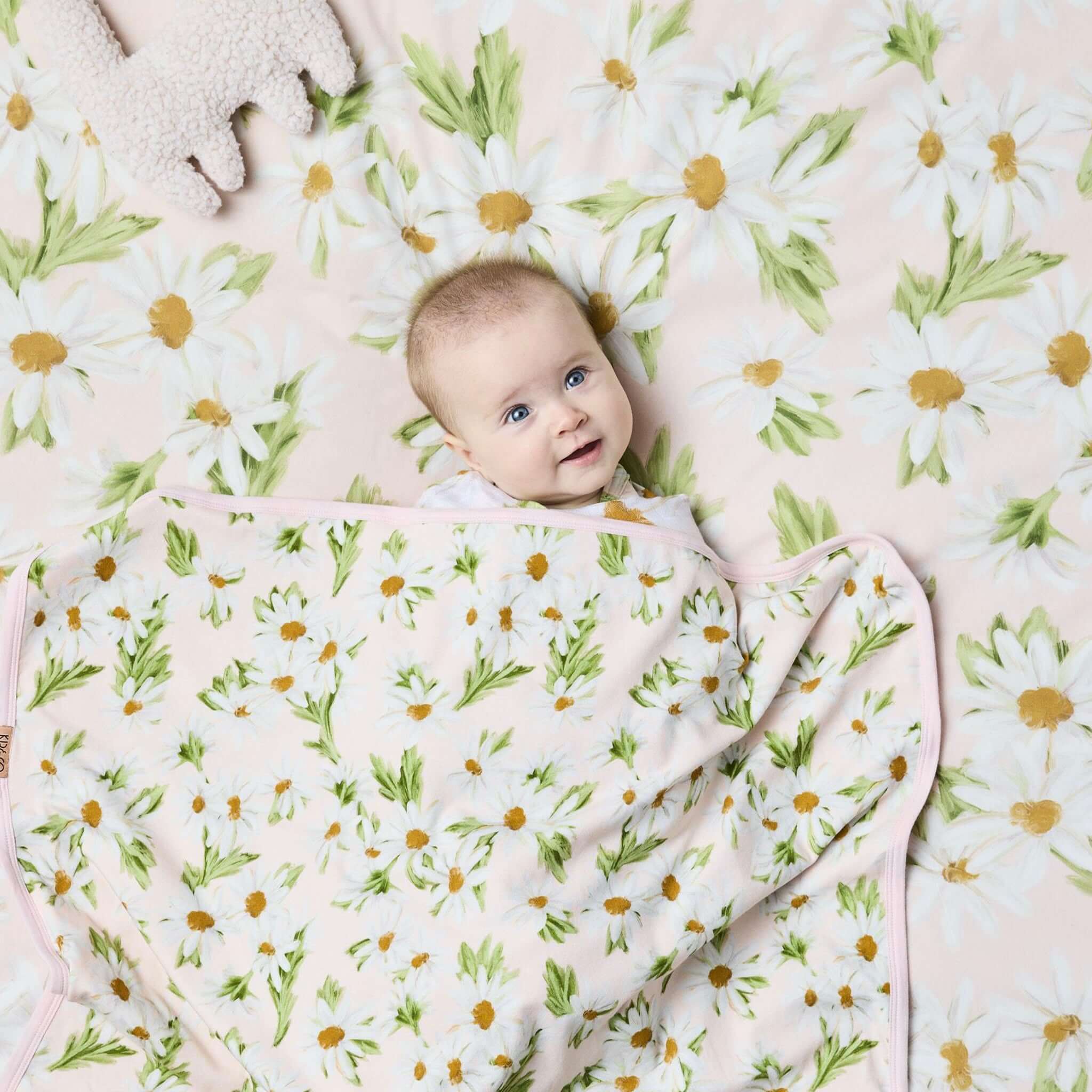 Alt Tag: Kip & Co Organic Cotton Baby Fitted Cot Sheet - Sweet Daisy pastel daisy floral cot bedding with baby on soft organic cotton