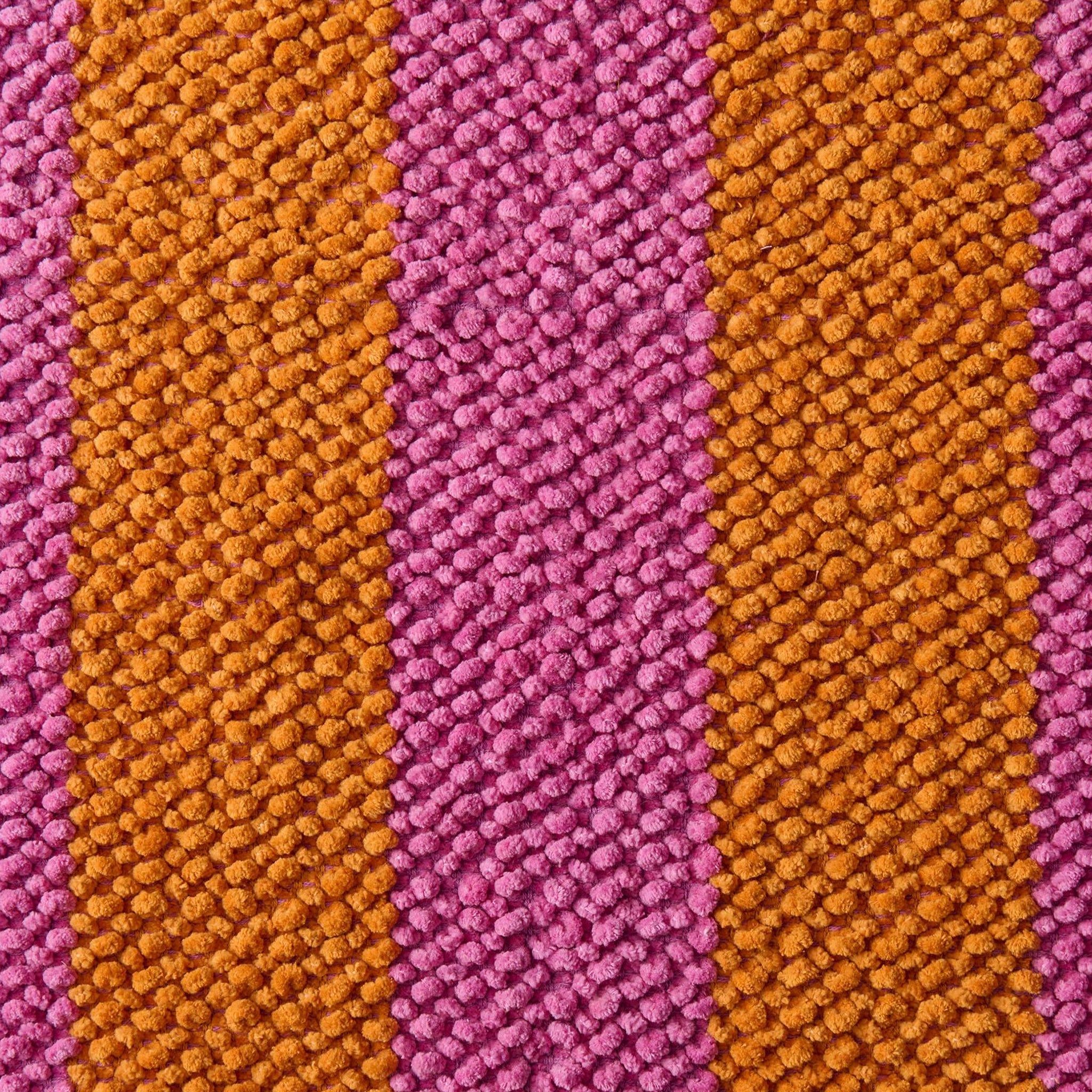 Close-up of striped fabric with alternating brown and pink stripes.