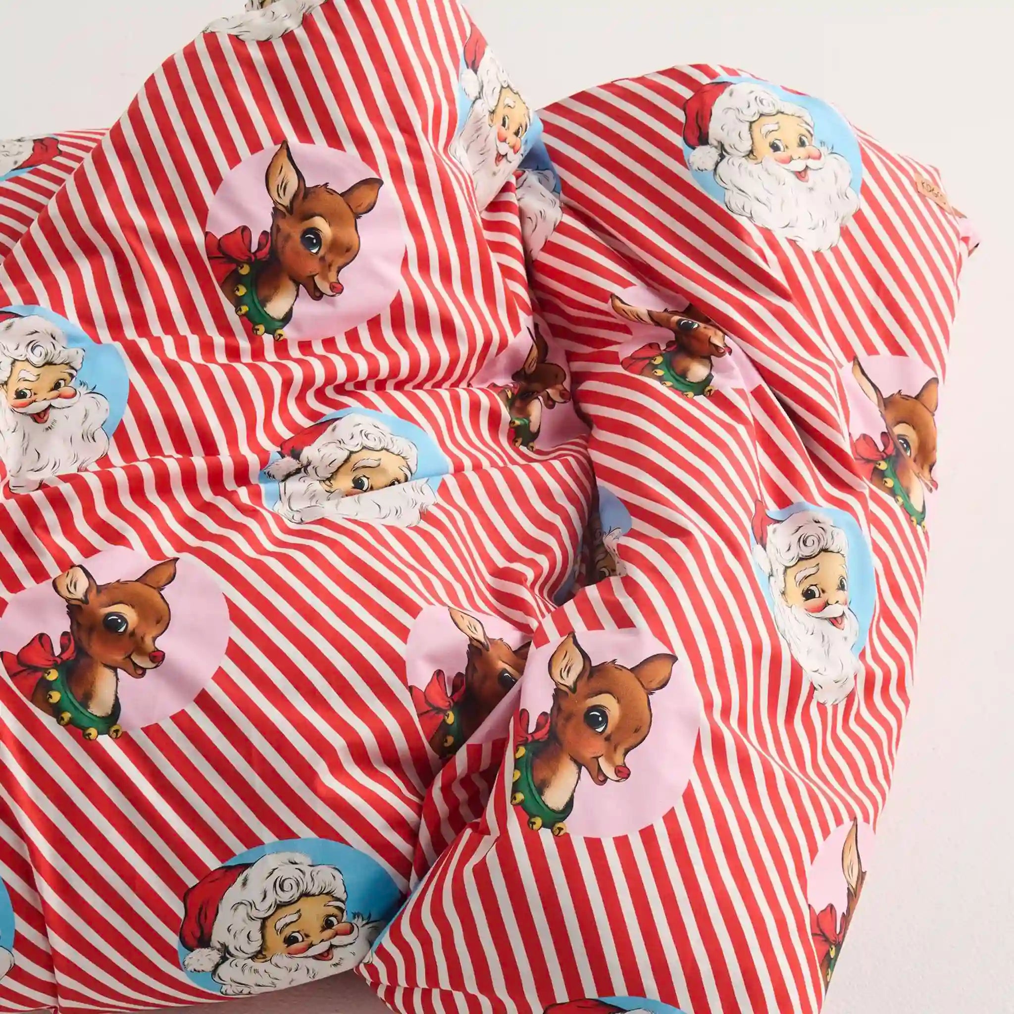 Red and white striped quilt with cartoon character prints on a white background
