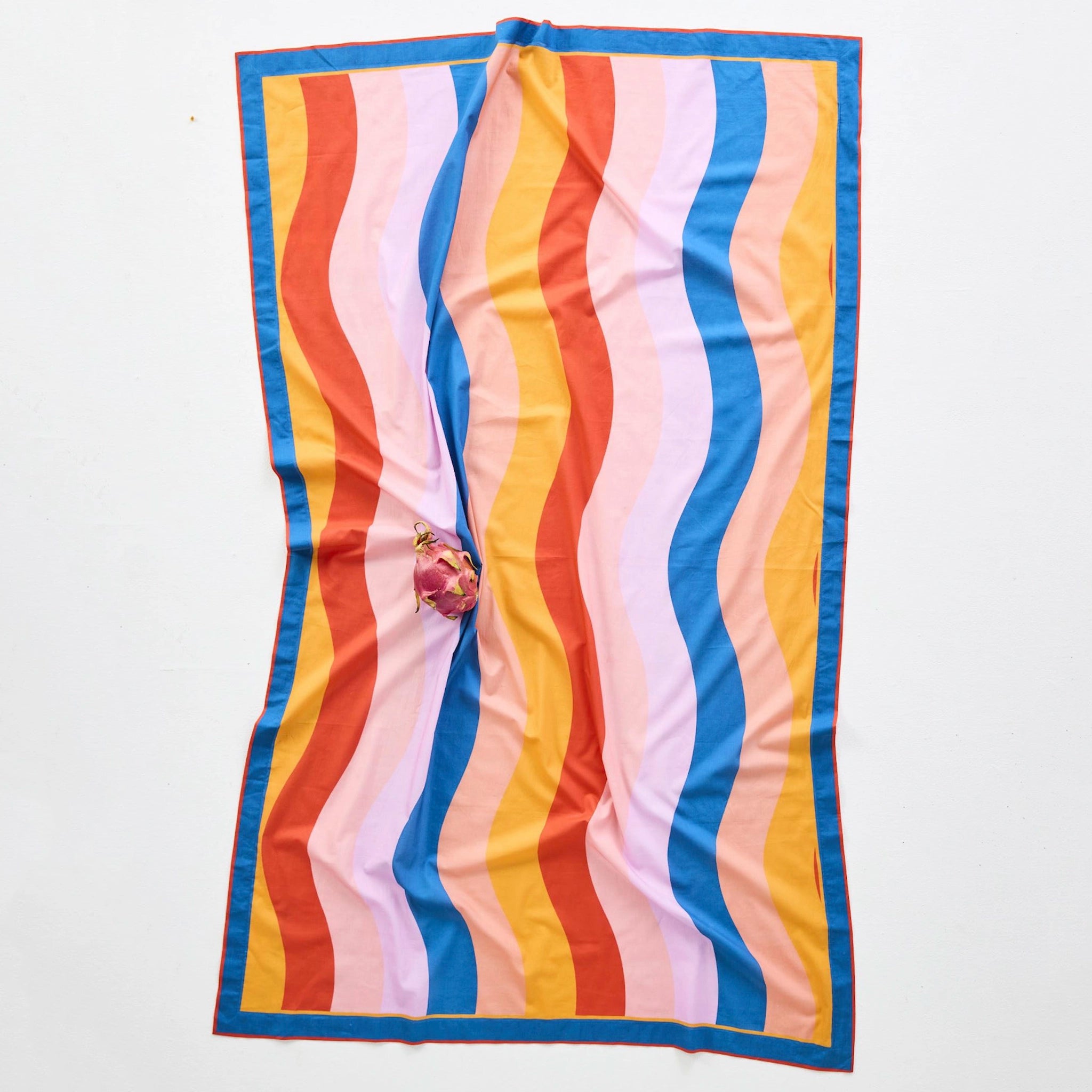 Colorful striped sarong with red, orange, pink, blue, and yellow stripes on a white background