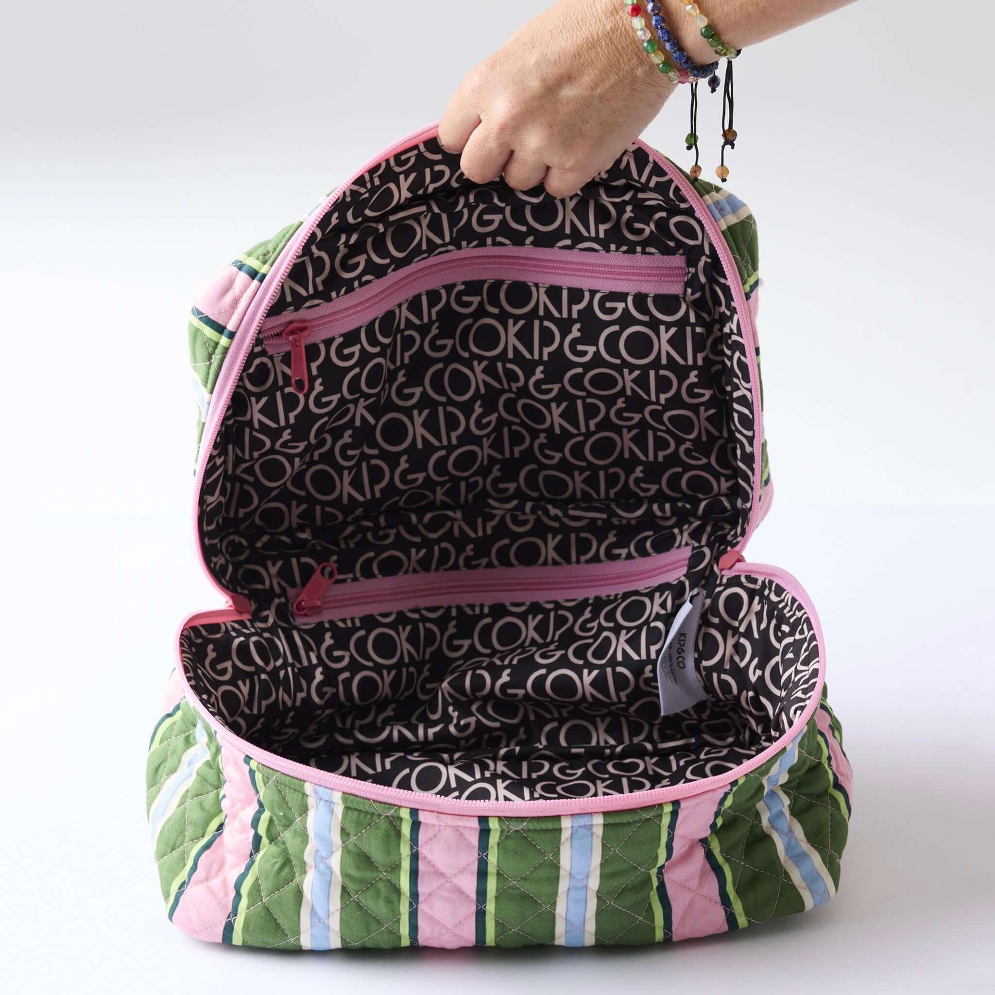 Alt Tag: Kip & Co Quilted Toiletry Case - Cactus Stripe open quilted cotton toiletry bag with striped exterior and zip compartments