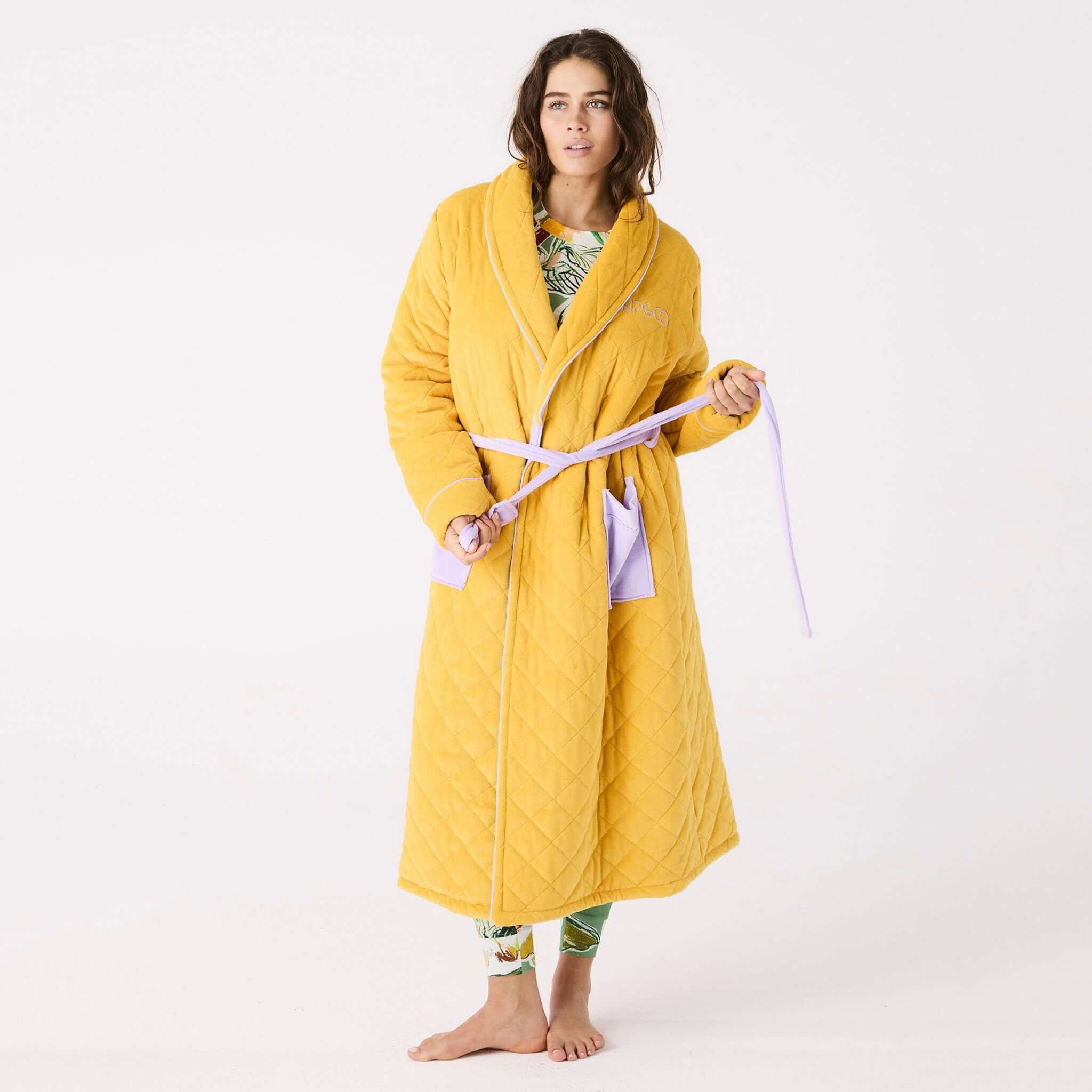 Alt Tag: Kip & Co Quilted Velvet Robe - Lavender Honey quilted light honey velvet robe with mauve pockets and waist tie on model