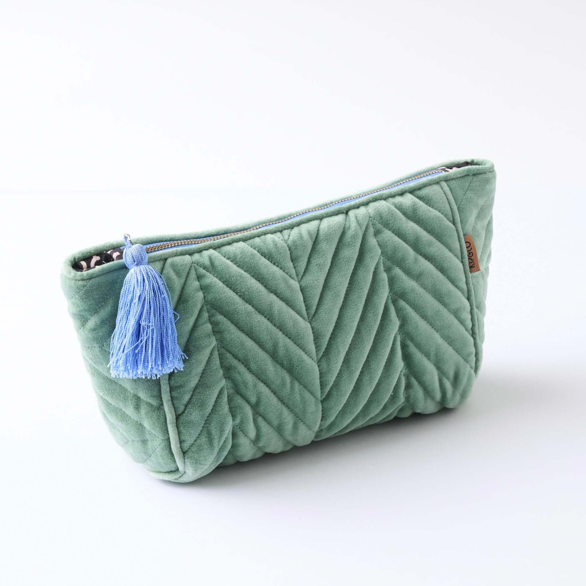 Alt Tag: Kip & Co Velvet Toiletry Bag - Seabed kelp green cotton velvet cosmetic bag with blue tassel and zip closure