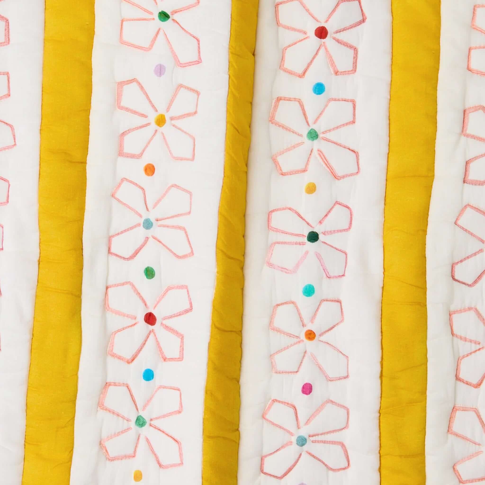Kip & Co x Anna Spiro Daisy Chain Organic Cotton Quilted Pillowslip with floral embroidery and colorful accents.