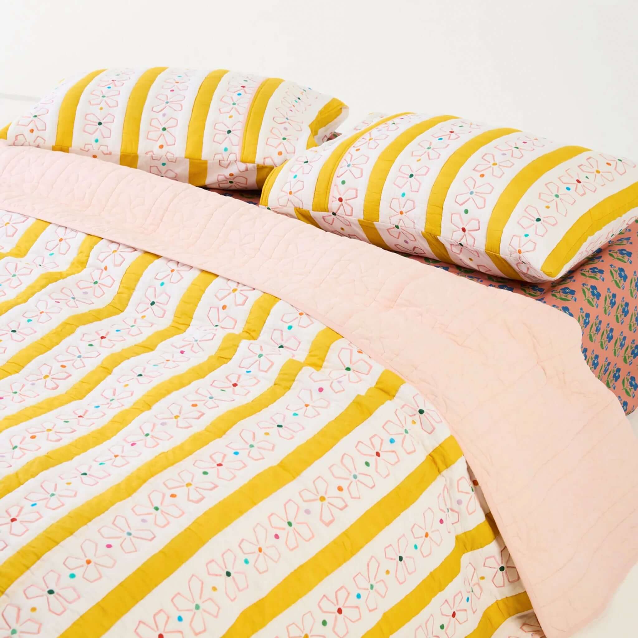 Kip & Co x Anna Spiro Daisy Chain Organic Cotton Quilted Bedspread - Large featuring floral and striped design.