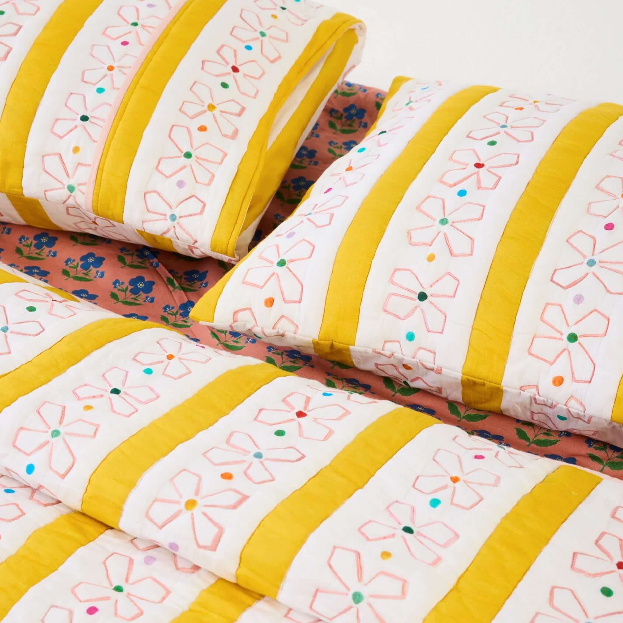 Kip & Co x Anna Spiro Daisy Chain Organic Cotton Quilted Pillowslip with floral design and vibrant colors.