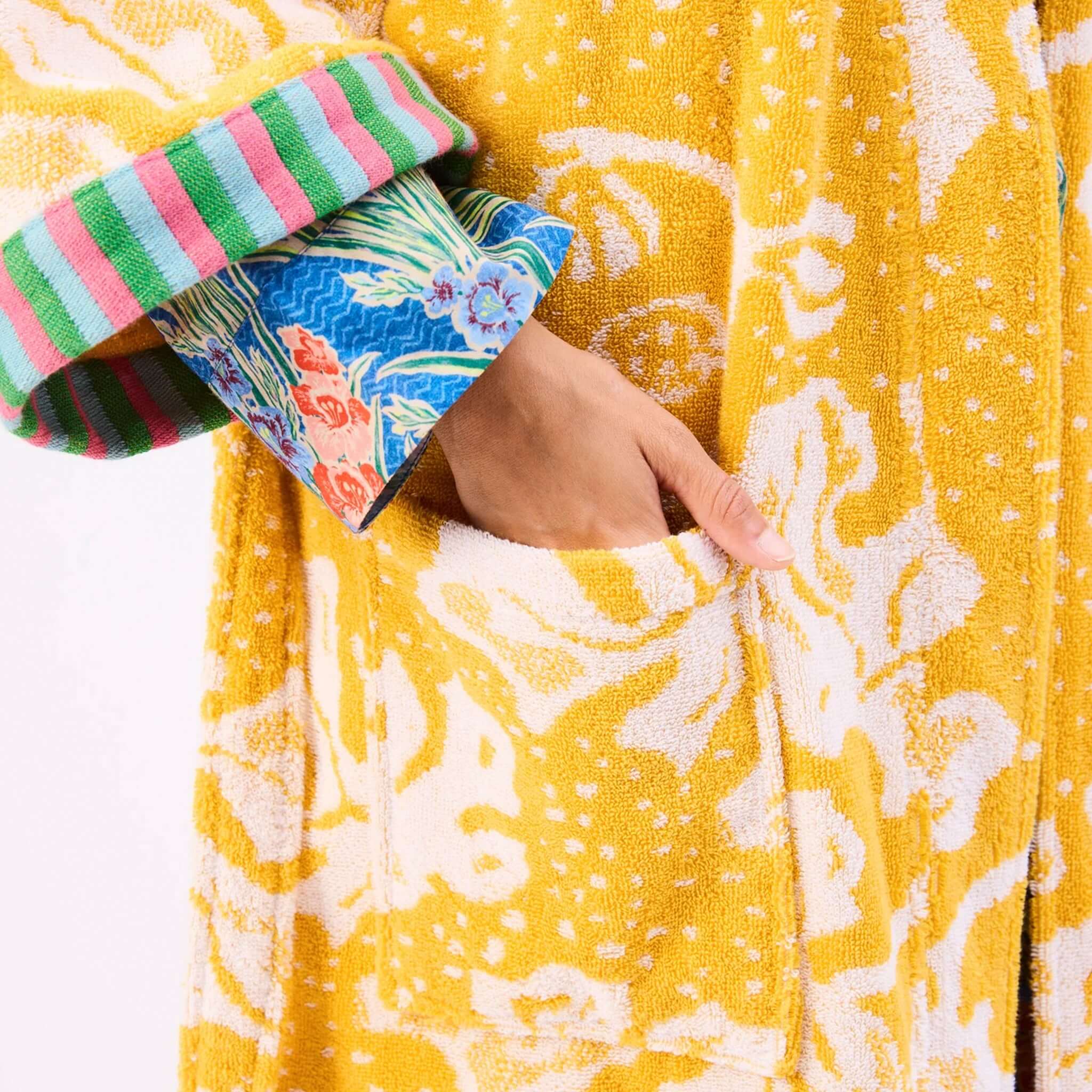 Close-up of the Kip & Co x Anna Spiro Elsternwig Fig Terry Bath Robe showing vibrant patterns and a pocket.