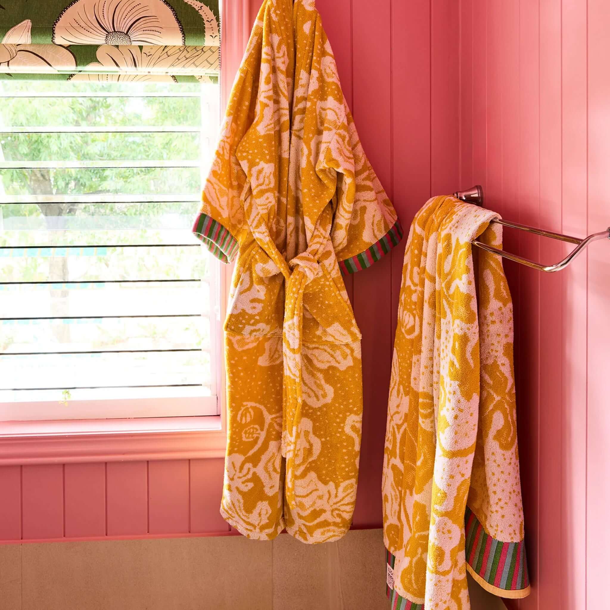 Kip & Co x Anna Spiro Elsternwig Fig Terry Bath Towel hanging in a colorful bathroom setting.