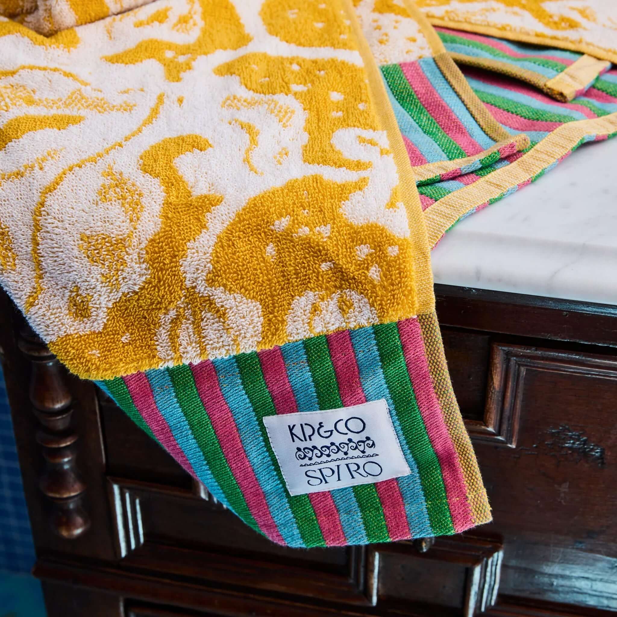 Kip & Co x Anna Spiro Elsternwig Fig Terry Face Washer with vibrant yellow and striped details.