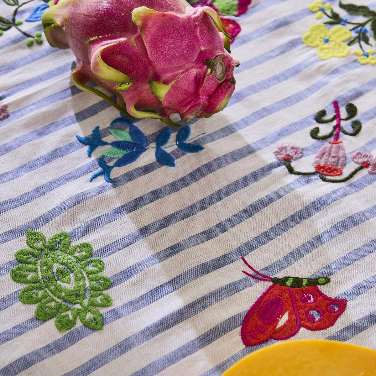 Kip & Co x Anna Spiro Tablecloth - Malabar Floral close-up of medallion and butterfly embroidery with dragon fruit