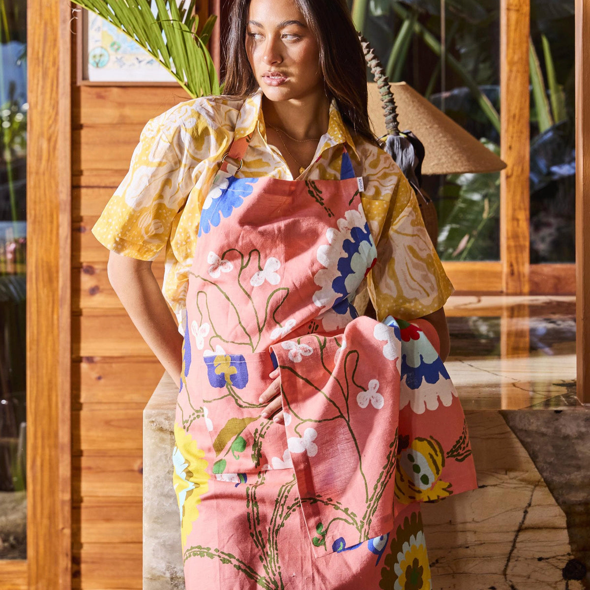 Kip & Co x Anna Spiro Isabelle Sunset print worn as an apron over a yellow shirt