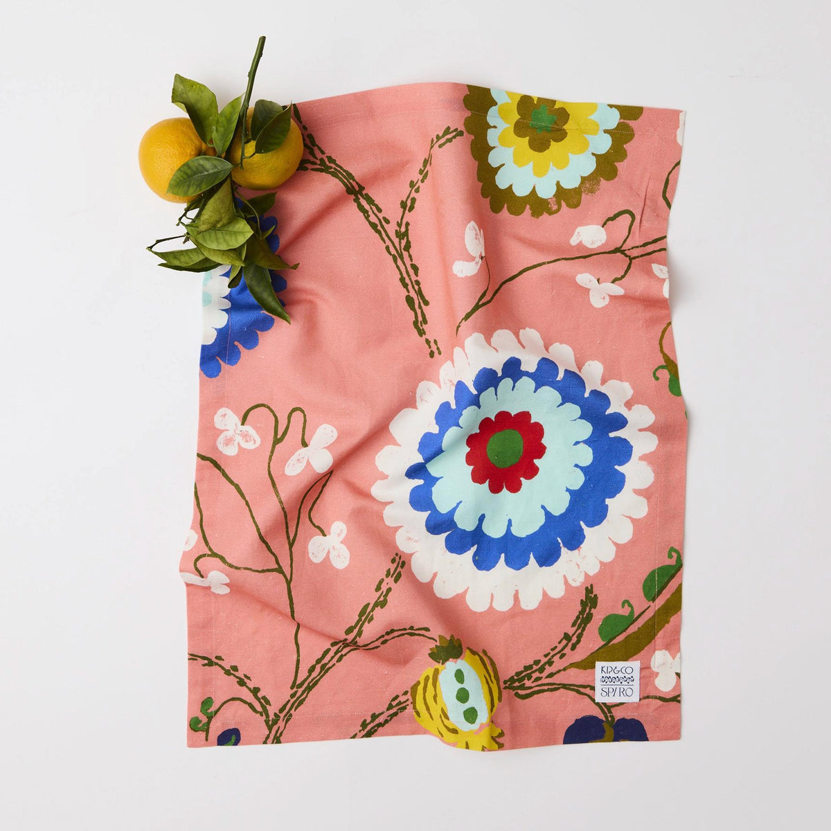 Kip & Co x Anna Spiro Linen & Cotton Tea Towel - Isabelle Sunset laid flat with a sprig of lemons
