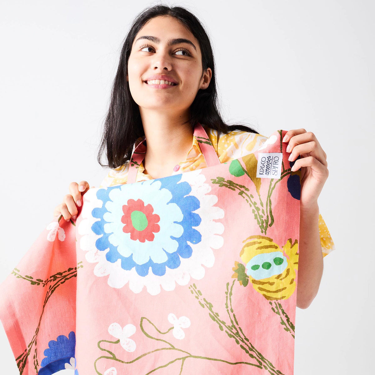Kip & Co x Anna Spiro Tea Towel - Isabelle Sunset held up by a smiling model