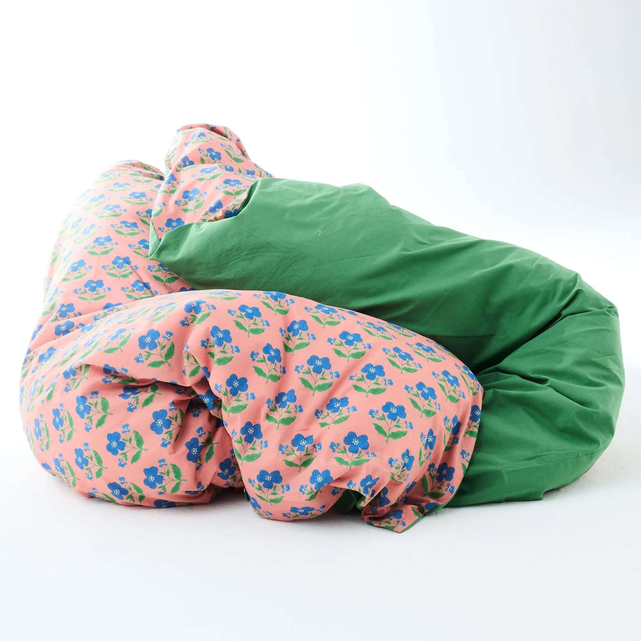 Kip & Co x Anna Spiro Organic Cotton Duvet Cover - Indian Summer Pink on a green background.