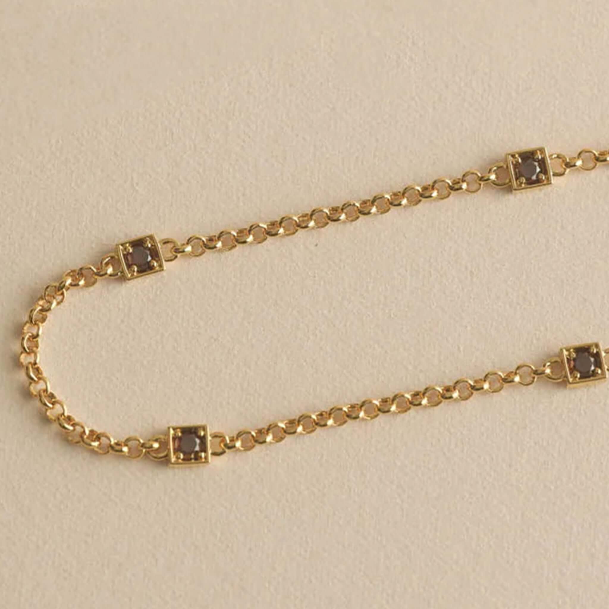 Kirstin Ash Ember Collection Renewal Bracelet - Gold Plated featuring gold chain and dark coffee cubic zirconia stones.