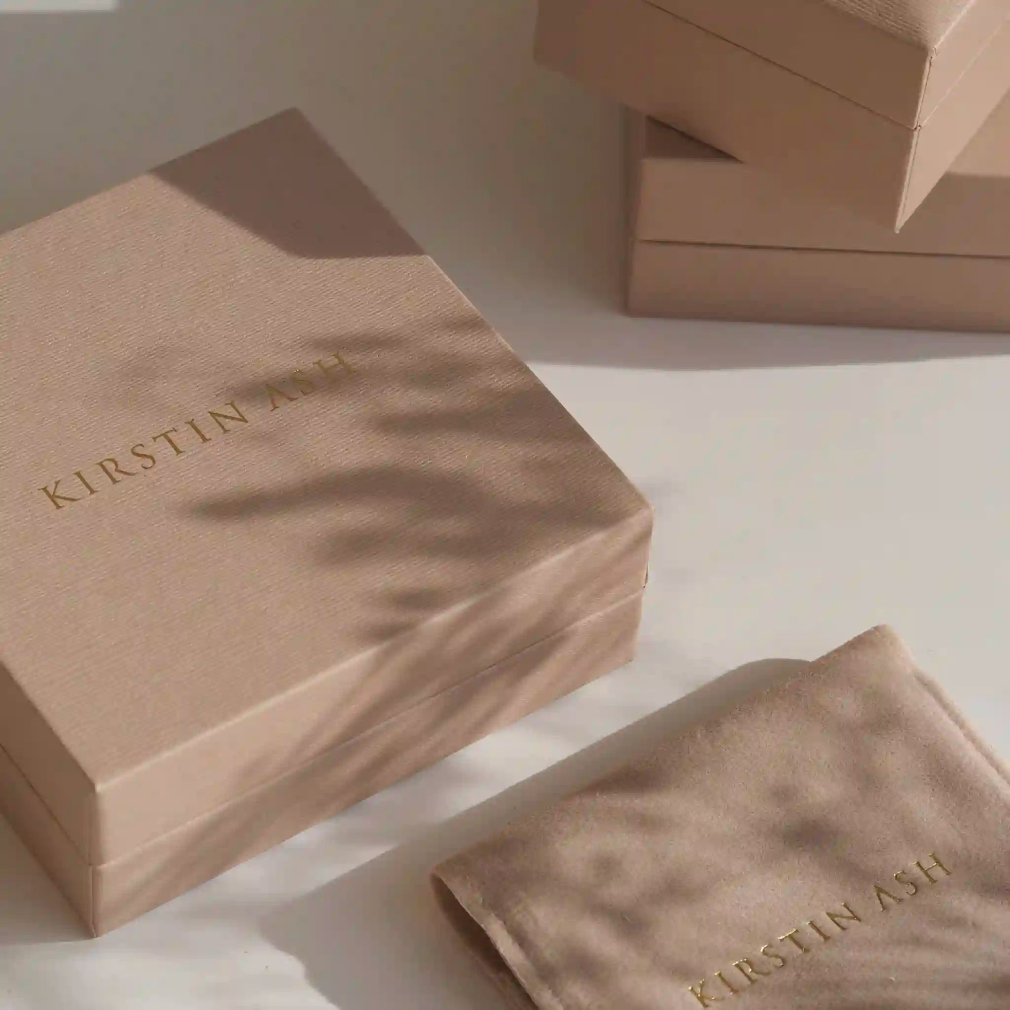 Kirstin Ash branded brown boxes on a light surface