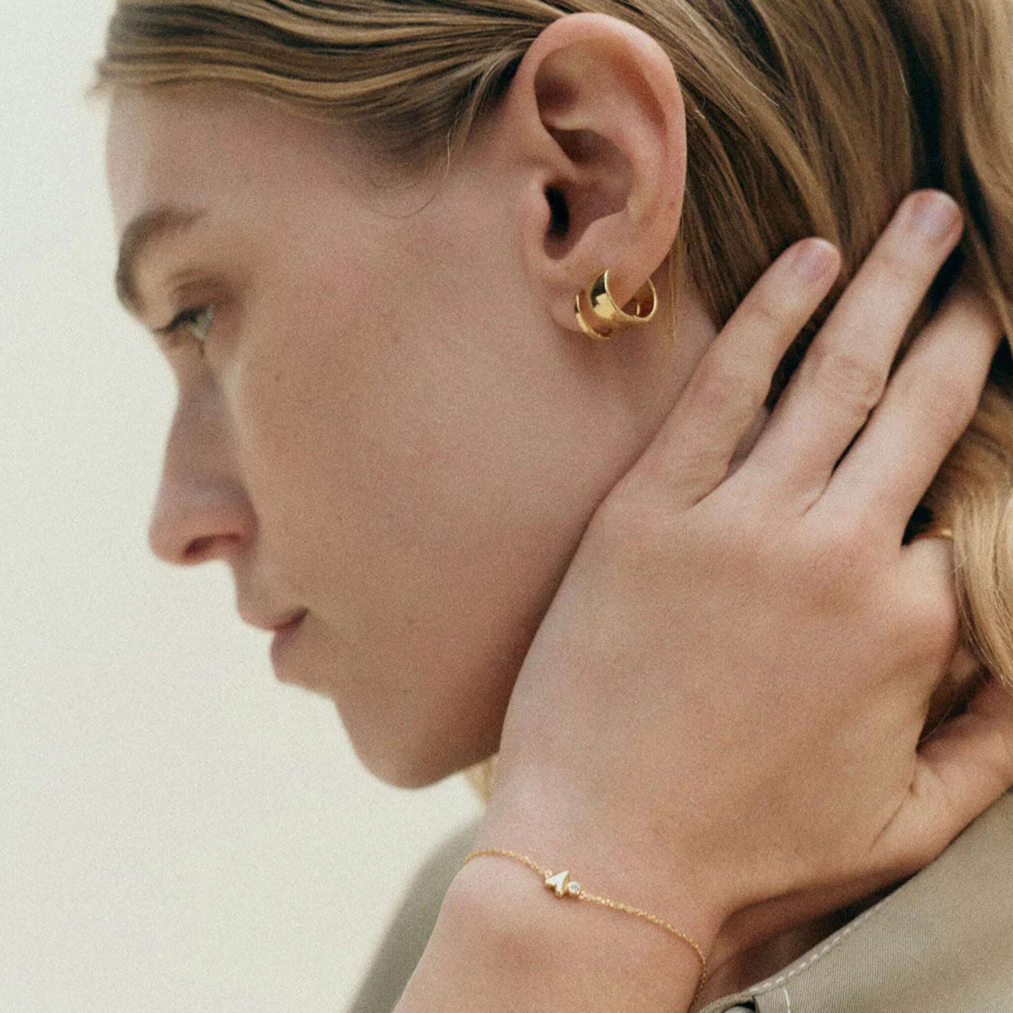 Alt Tag: Kirstin Ash Vista Collection Abode Heart Bracelet in 18k gold-plated, delicate chain with organic heart and white topaz on wrist