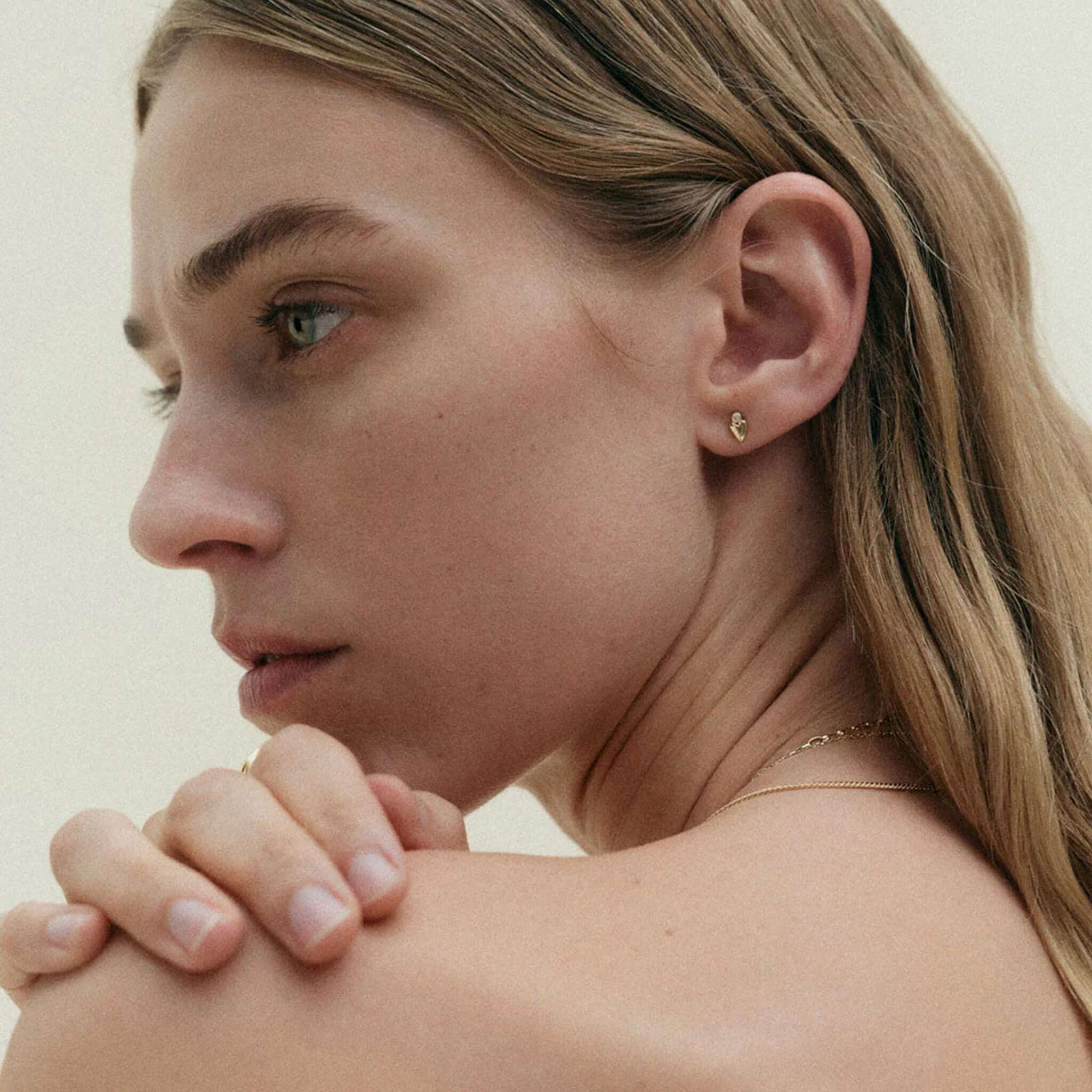 Alt Tag: Kirstin Ash Vista Collection Abode Heart Stud Earrings on model, petite heart stud with white topaz gemstone, gold-plated