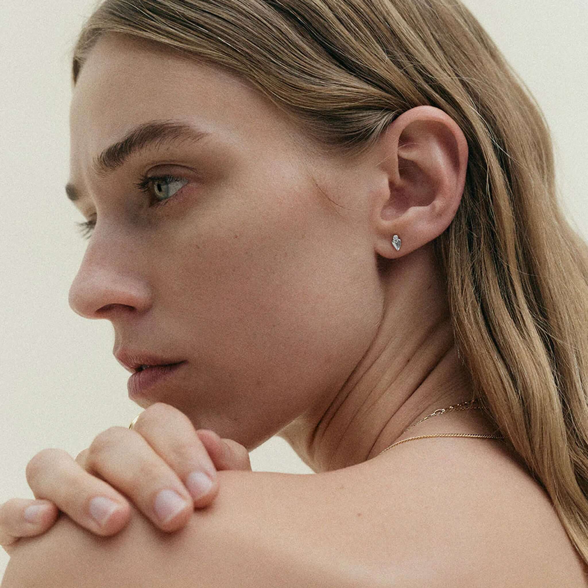 Kirstin Ash Vista Collection Abode Heart Stud Earrings on model, petite heart stud with white topaz gemstone in sterling silver