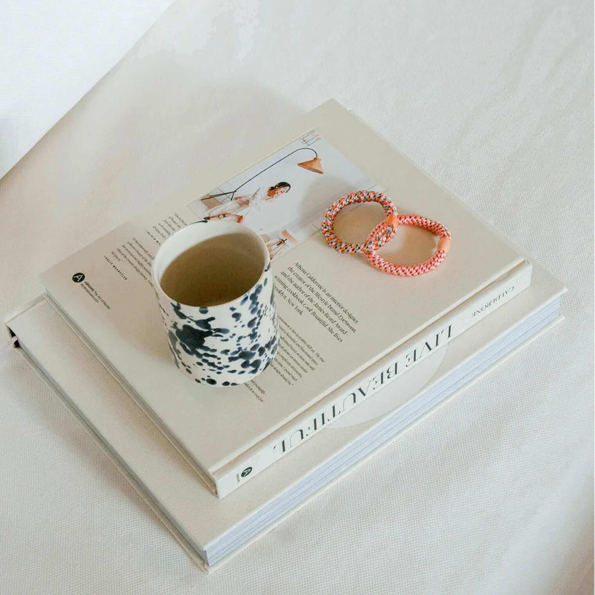 Kknekki Hair Tie - Mix Orange Pistachio Glitter coral glitter stripe woven hair ties on books beside ceramic mug