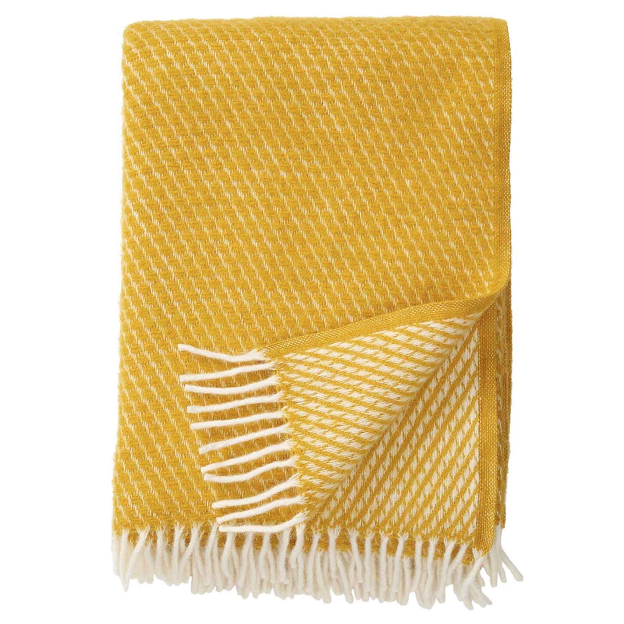 Klippan Yllefabrik Velvet Lambswool Throw - Saffron draped on a surface with cream fringe trim.