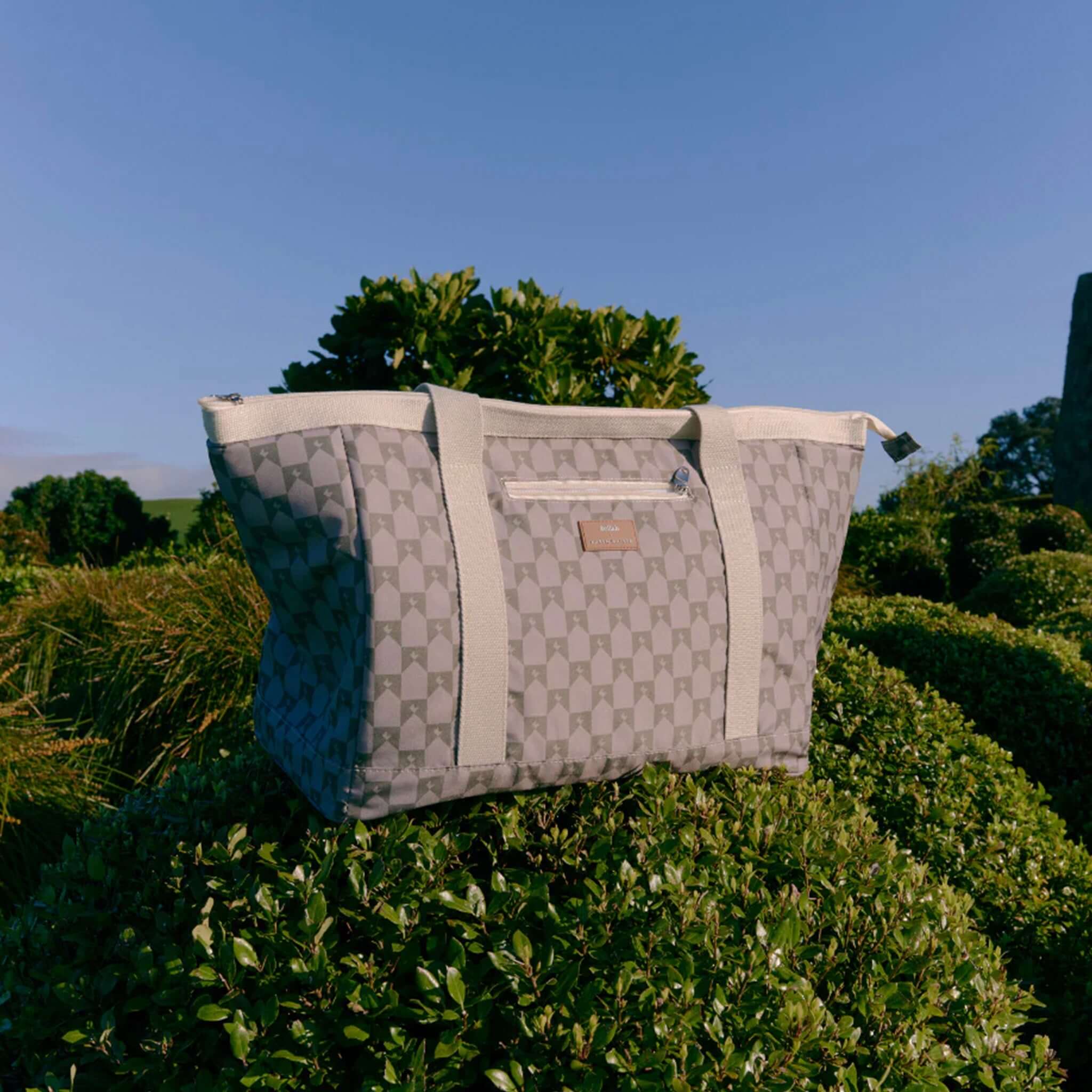 Alt Tag: Kollab x Karen Walker Tote Bag - Sage Monogram holiday tote cooler bag with sage monogram print, outdoor lifestyle product photo