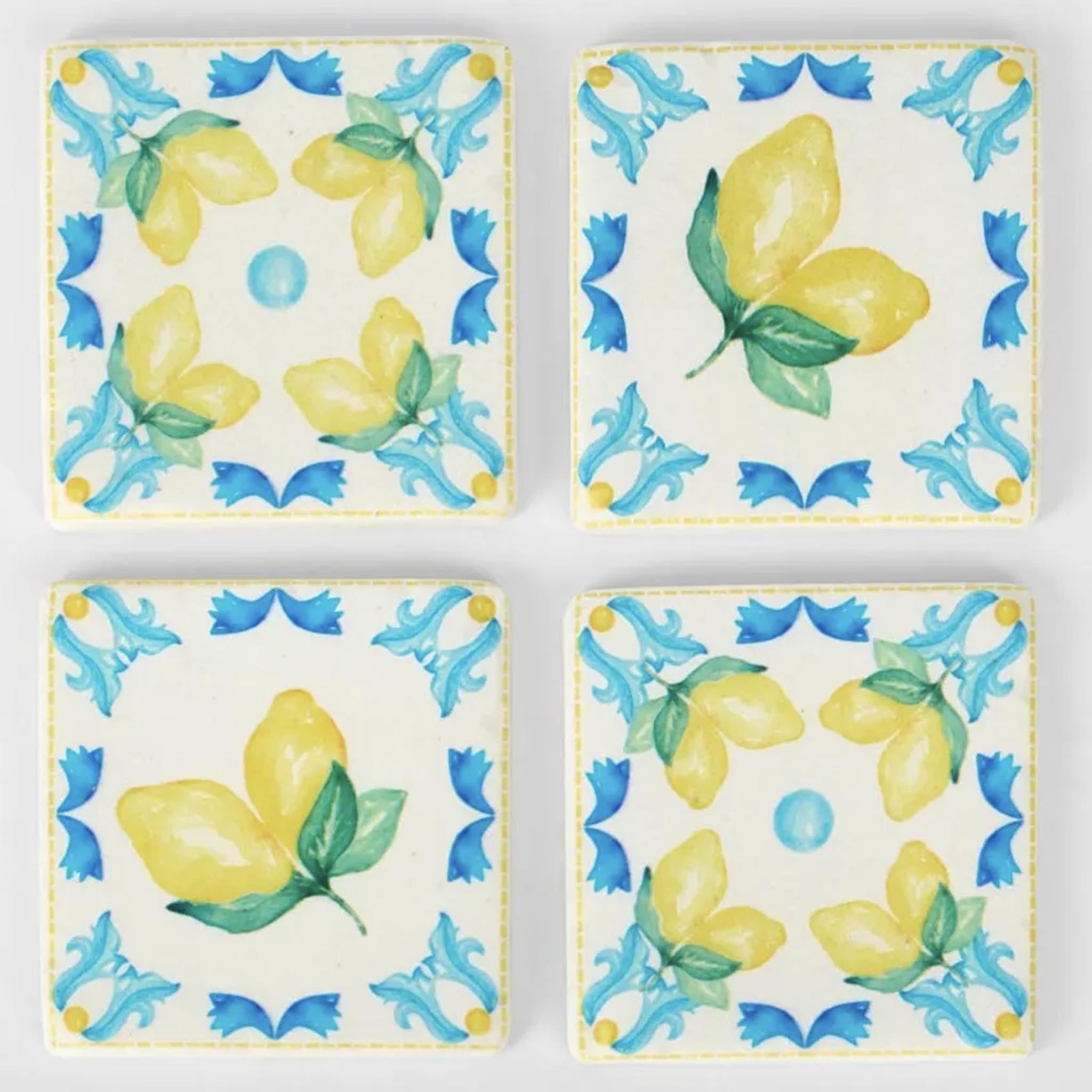 Set of four ceramic coasters with lemon and butterfly design on a white background