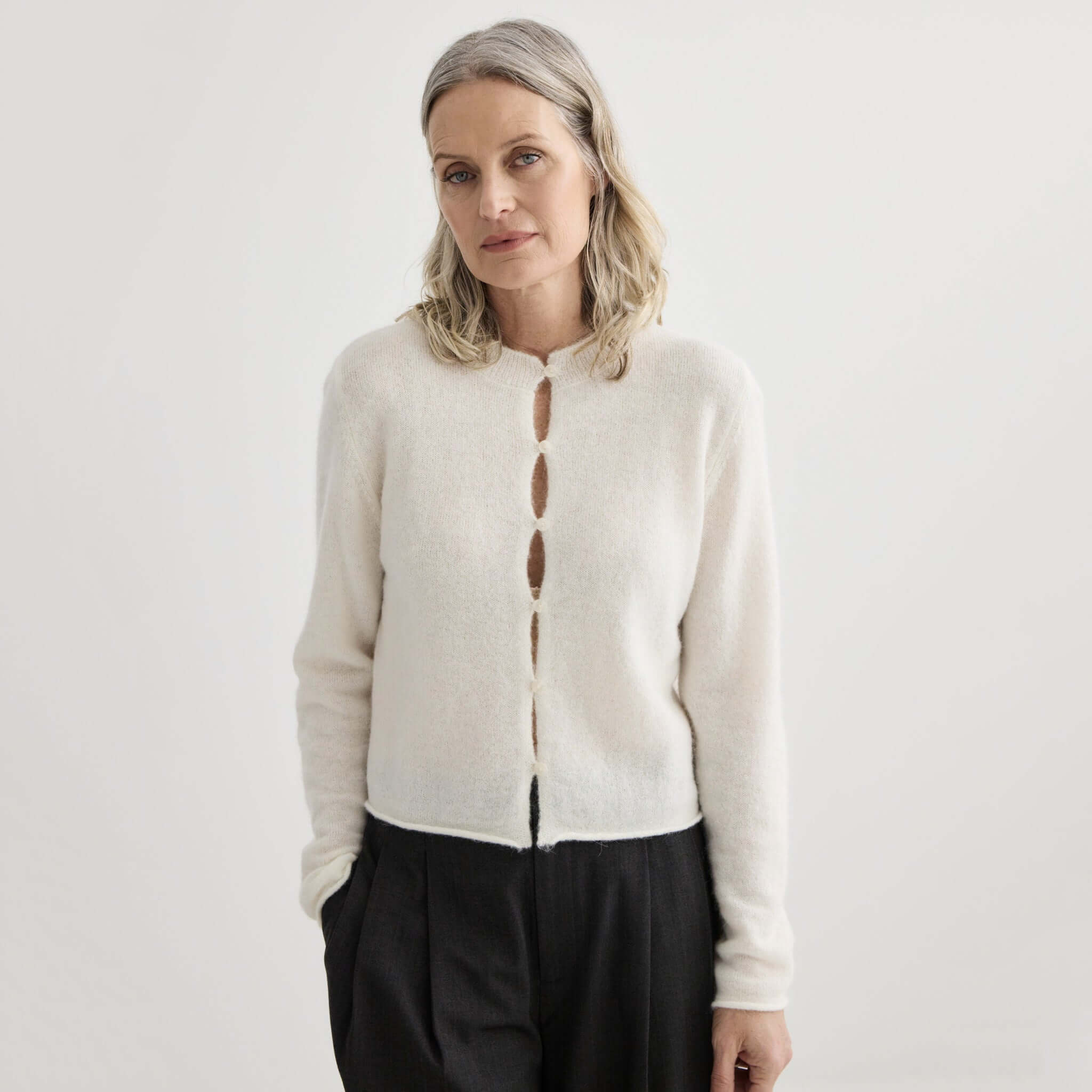 Laing Alpaca / Merino Cropped Cardigan - Ivory on model, soft alpaca-merino knit with rolled hems, lightweight warm layering piece