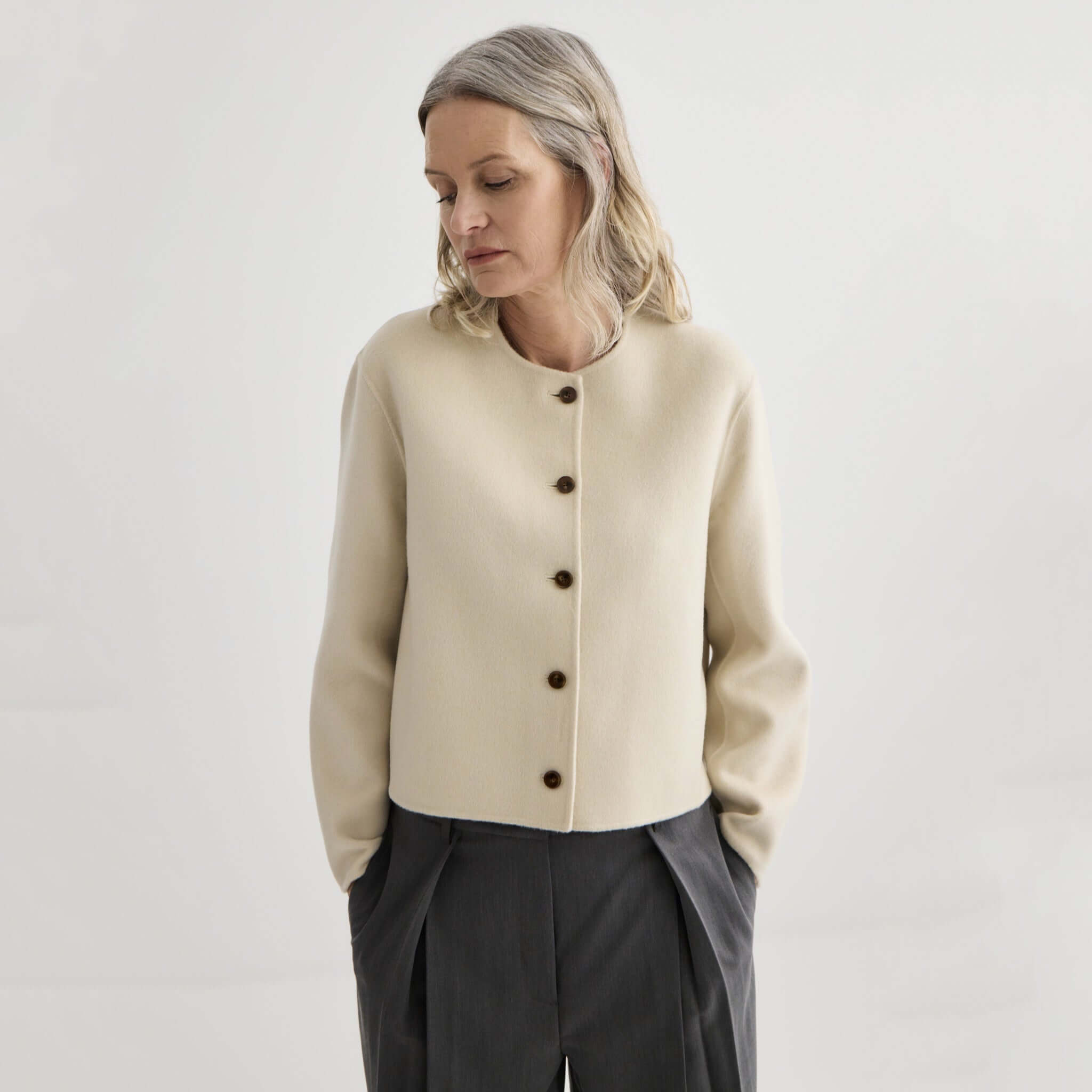 Alt Tag: Laing Cashmere & Wool Cardi Jacket - Ivory cropped collarless cashmere-wool jacket in ivory with button front, worn by model