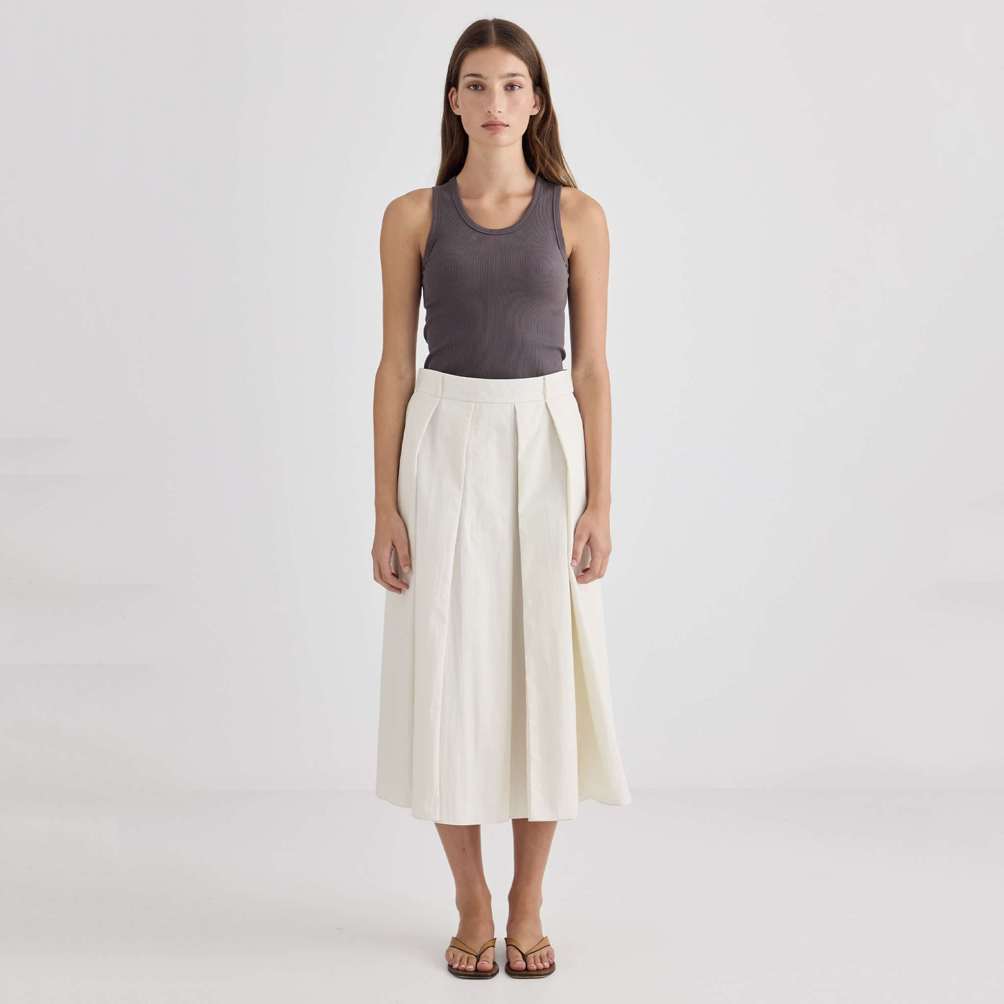 Laing Ellis Pleated Skirt - Cream worn by model with tank top and sandals against a plain background.