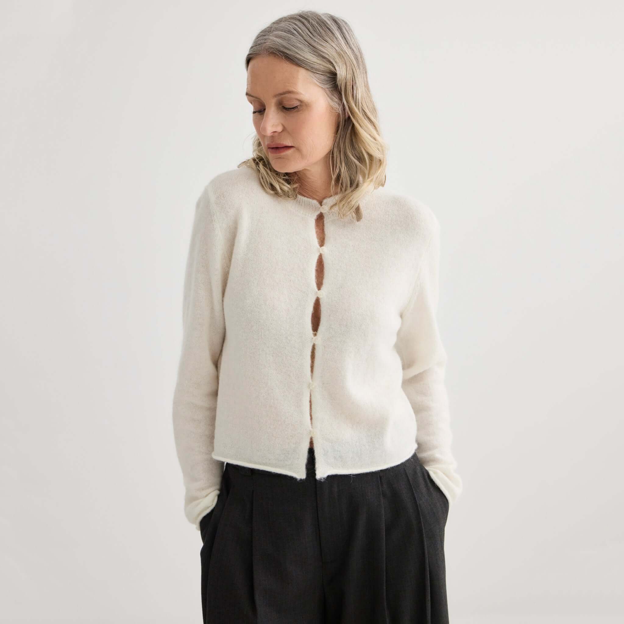 Alt Tag: Laing Alpaca / Merino Cropped Cardigan - Ivory on model, soft lightweight knit with rolled hems, breathable warm layering