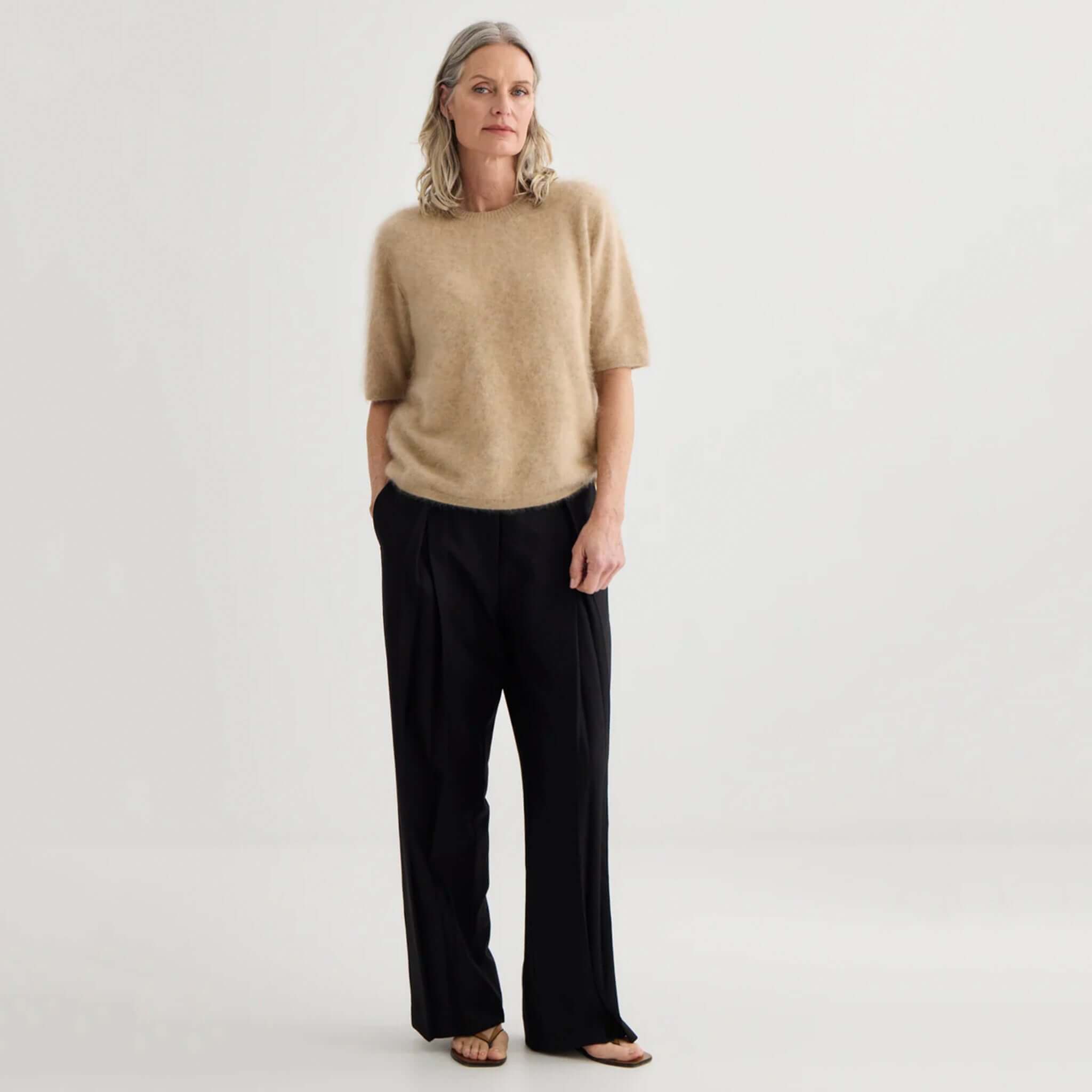 Alt Tag: Laing Brushed Cashmere T Shirt - Soft Beige women's brushed cashmere tee, relaxed fit, styled with wide-leg black pants