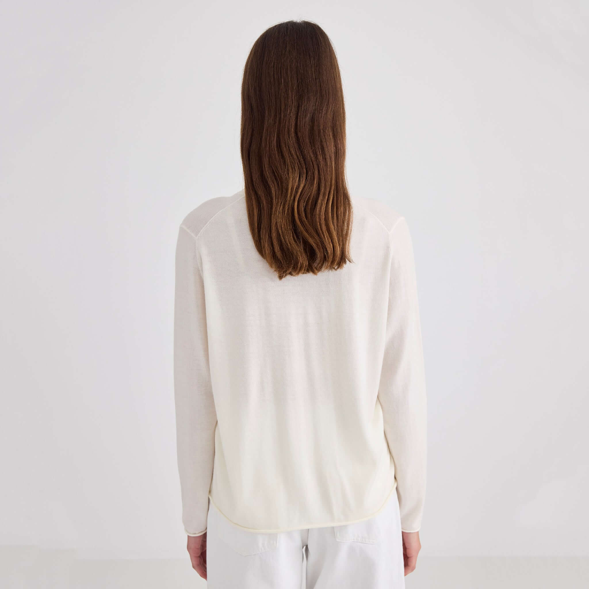 Laing Liv V-Neck Merino Cardigan - Cream worn from the back, showcasing its soft and relaxed fit.