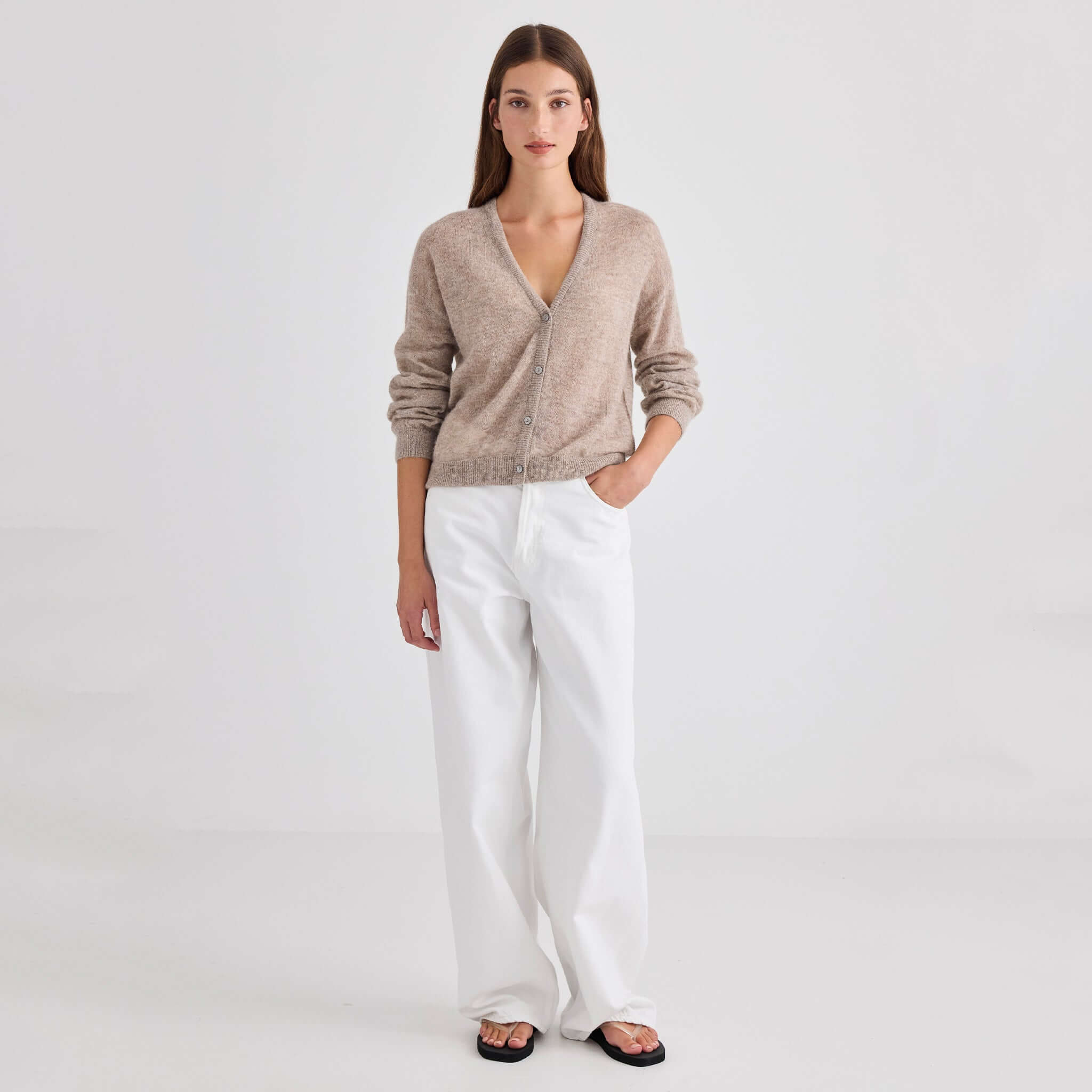 Laing Mila Alpaca & Merino Cardigan - Hazel worn with white trousers and sandals, showcasing its relaxed style.