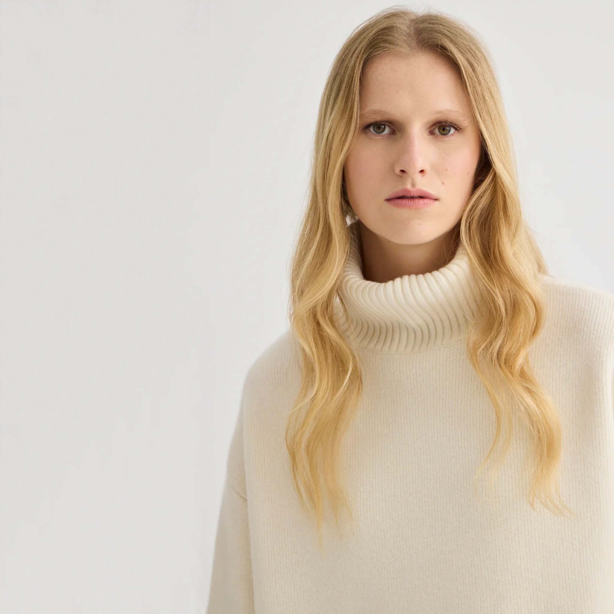 Laing Nico Merino Oversized Sweater - Cream featuring a model with long hair in a turtleneck design.