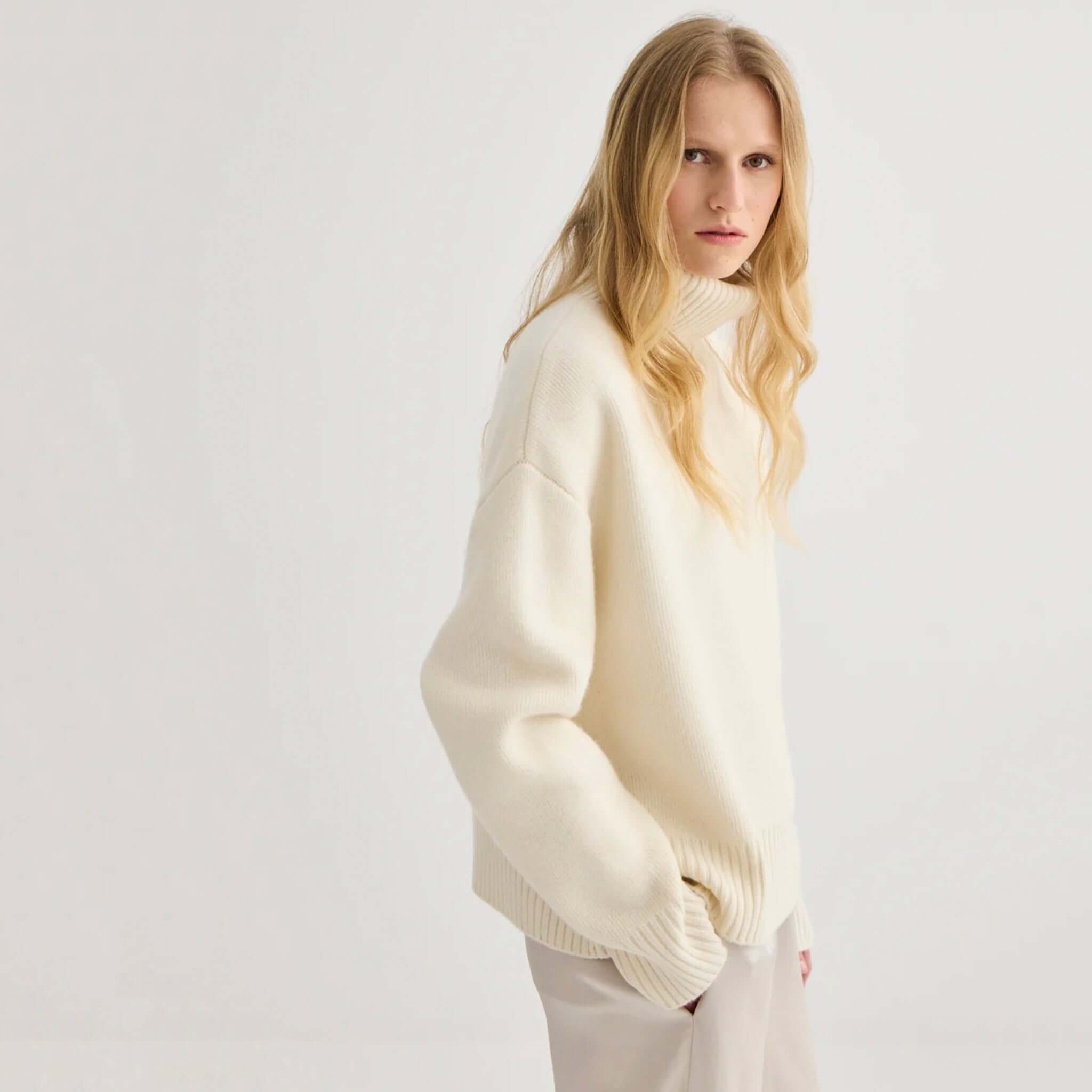 Laing Nico Merino Oversized Sweater - Cream displayed in a relaxed fit with a turtleneck and wide ribbed cuffs.