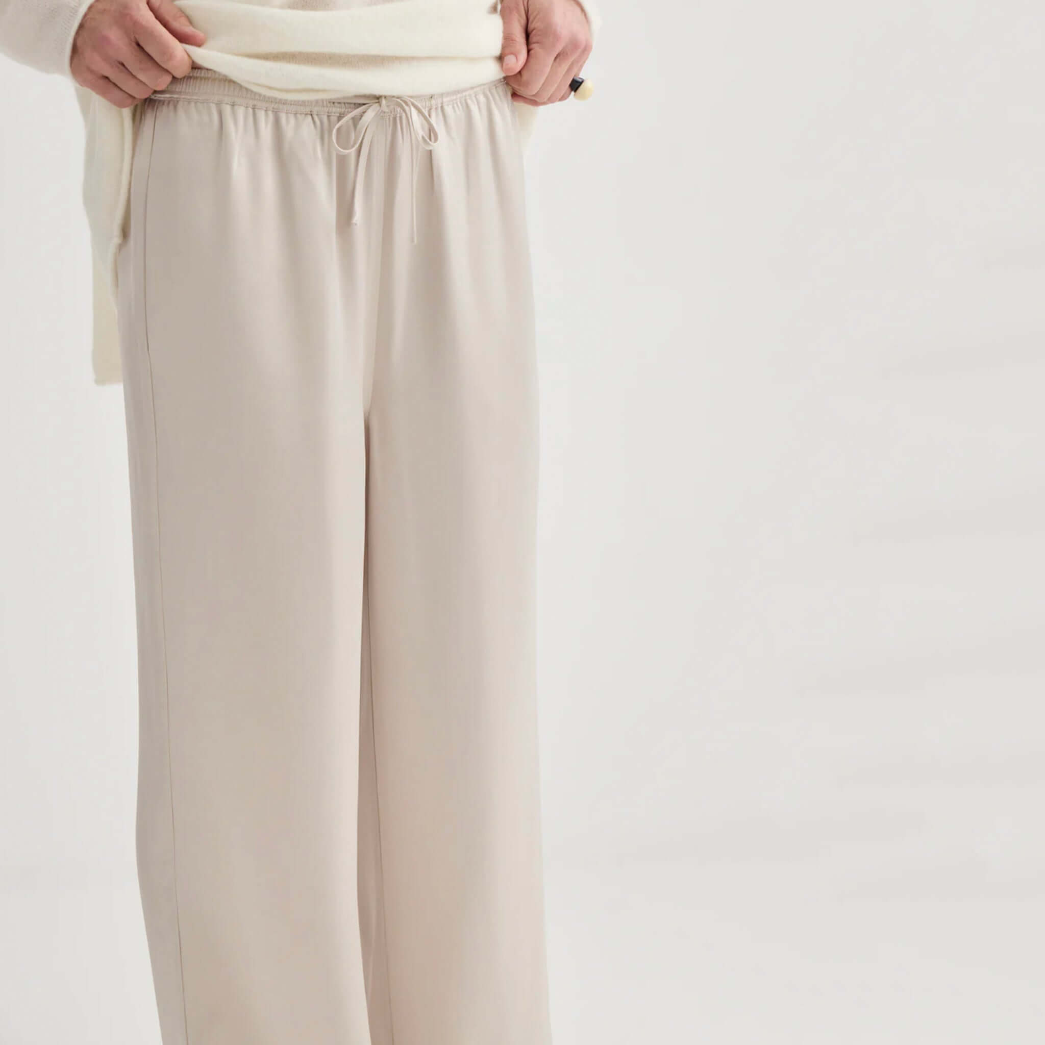 Alt Tag: Laing Satin Relaxed Pants - Champagne wide leg satin trousers in soft champagne tone with drawstring waist, elegant drape
