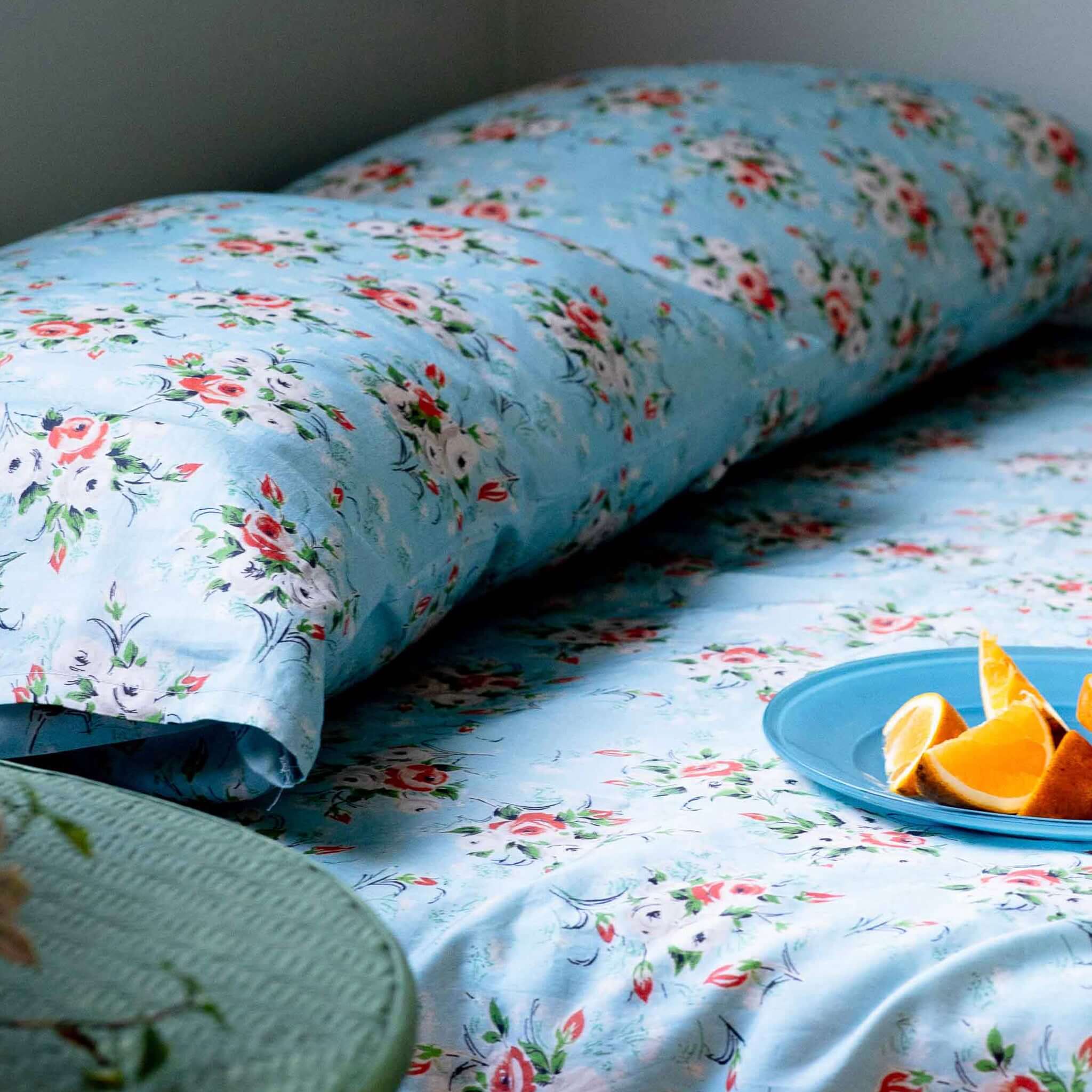 Alt Tag: Lazybones Organic Cotton Bedlinen Set - Rosebank in sky blue with coral, grey and white rose print organic cotton sheets