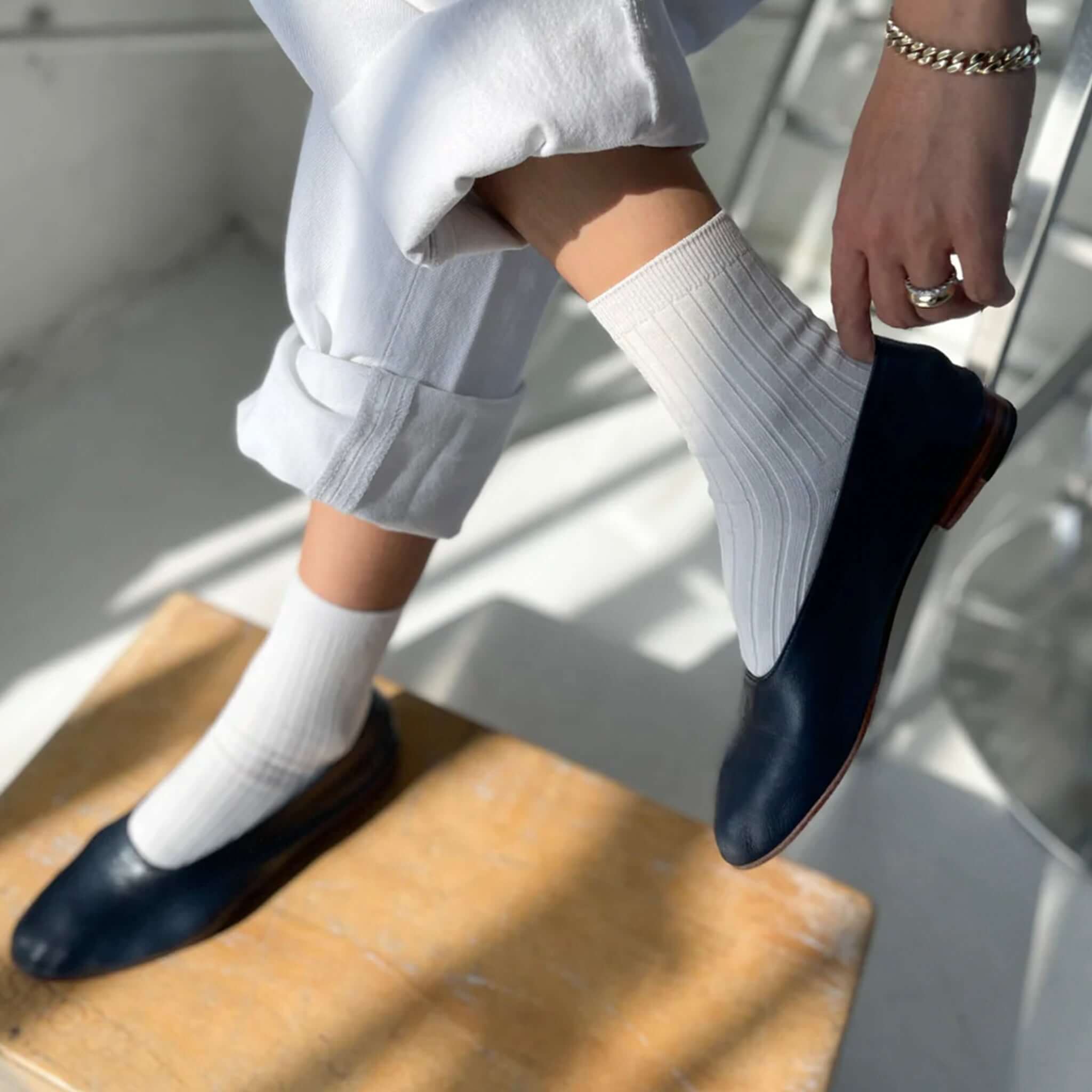 Le Bon Shoppe Her Cotton Socks - Classic White styled with navy flats, showcasing their versatile design and classic ribbed look.