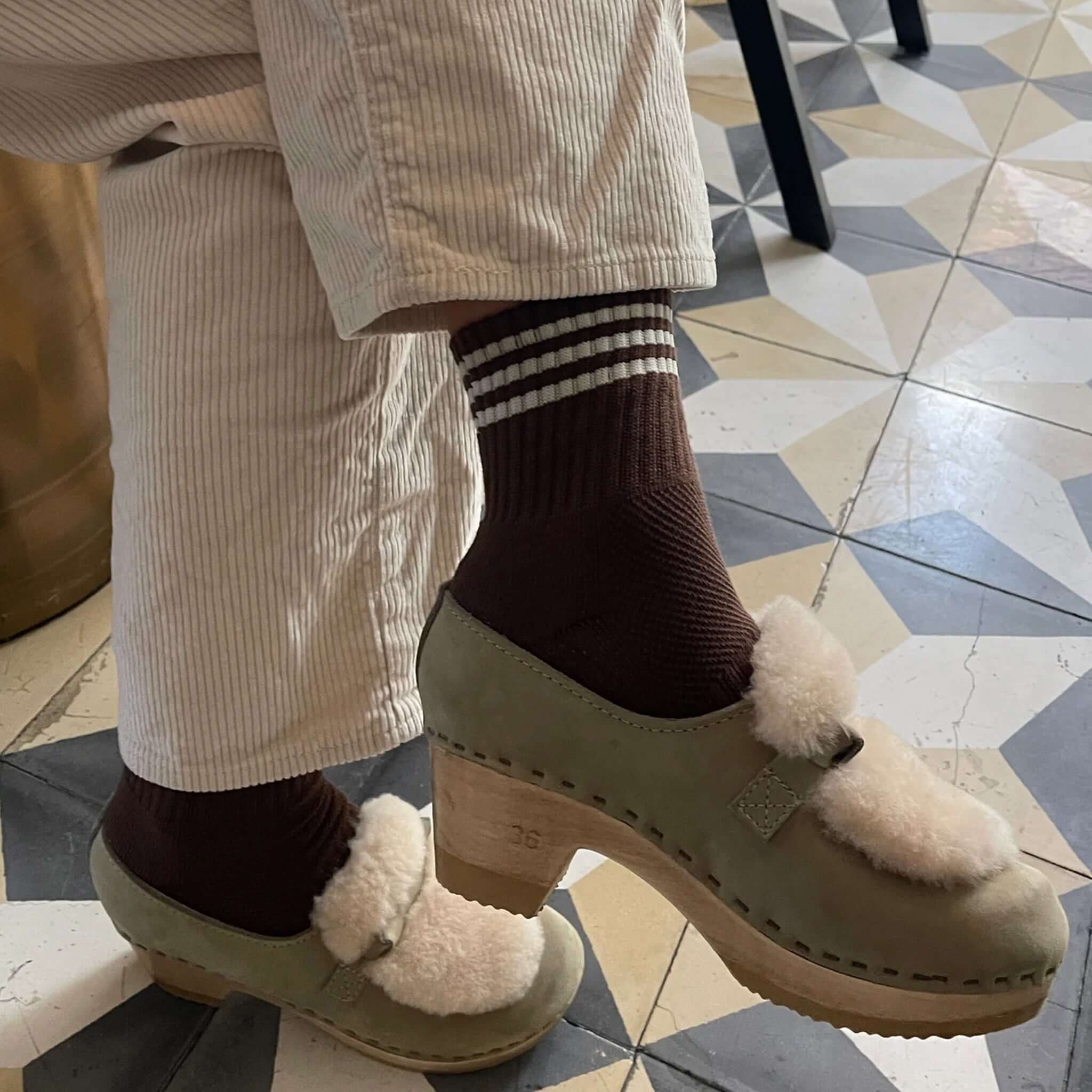 Le Bon Shoppe Girlfriend Socks - Mahogany paired with stylish clogs on a patterned tile floor.
