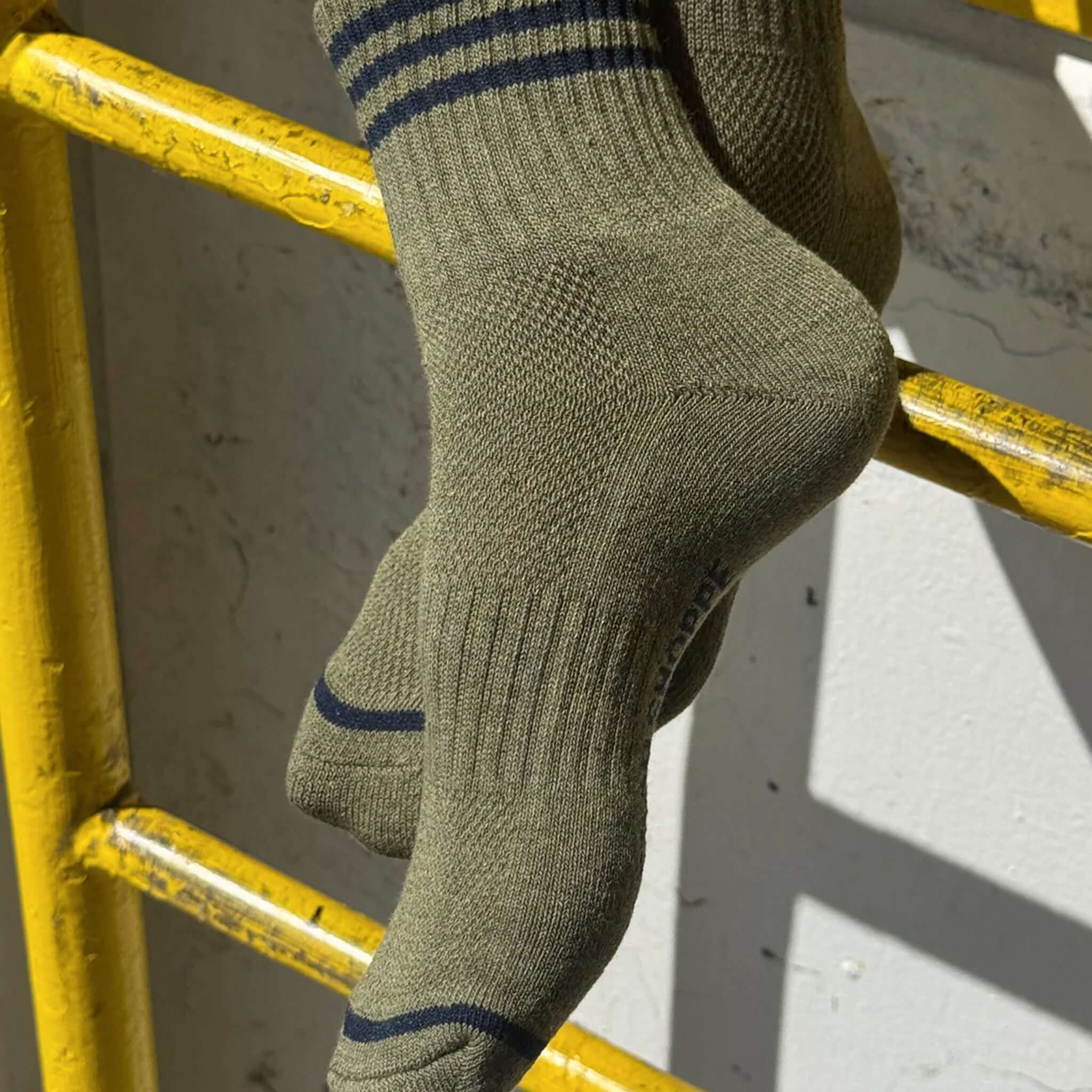 Le Bon Shoppe Girlfriend Socks - Sage displayed on a yellow ladder, showcasing triple contrast stripes.