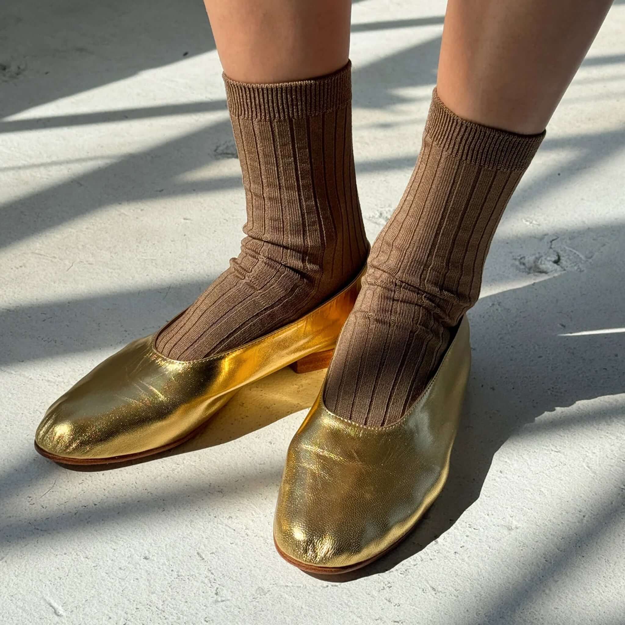 Le Bon Shoppe Her Cotton Socks - Dark Tan worn with golden shoes on a light background.