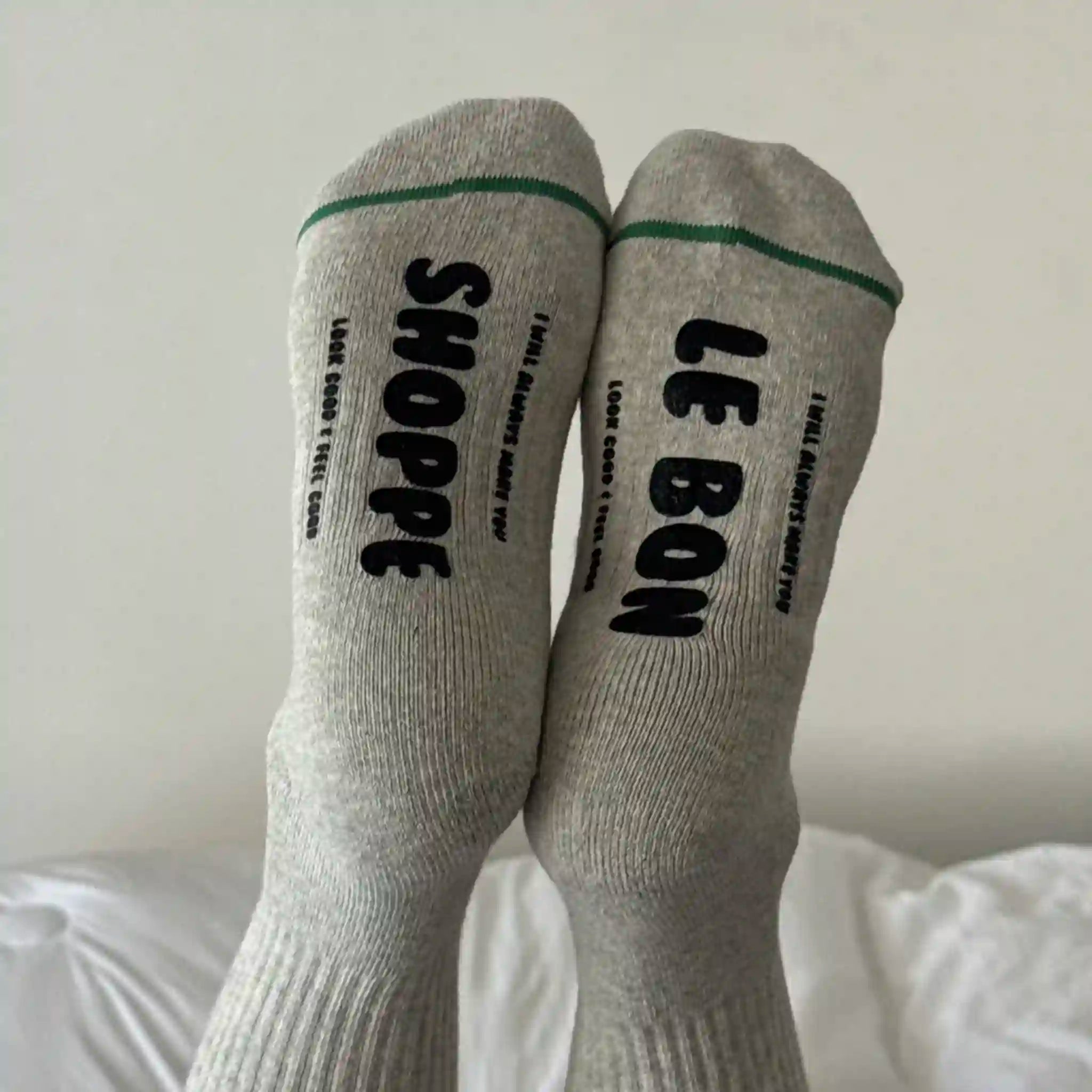 Gray socks with black text on a white background