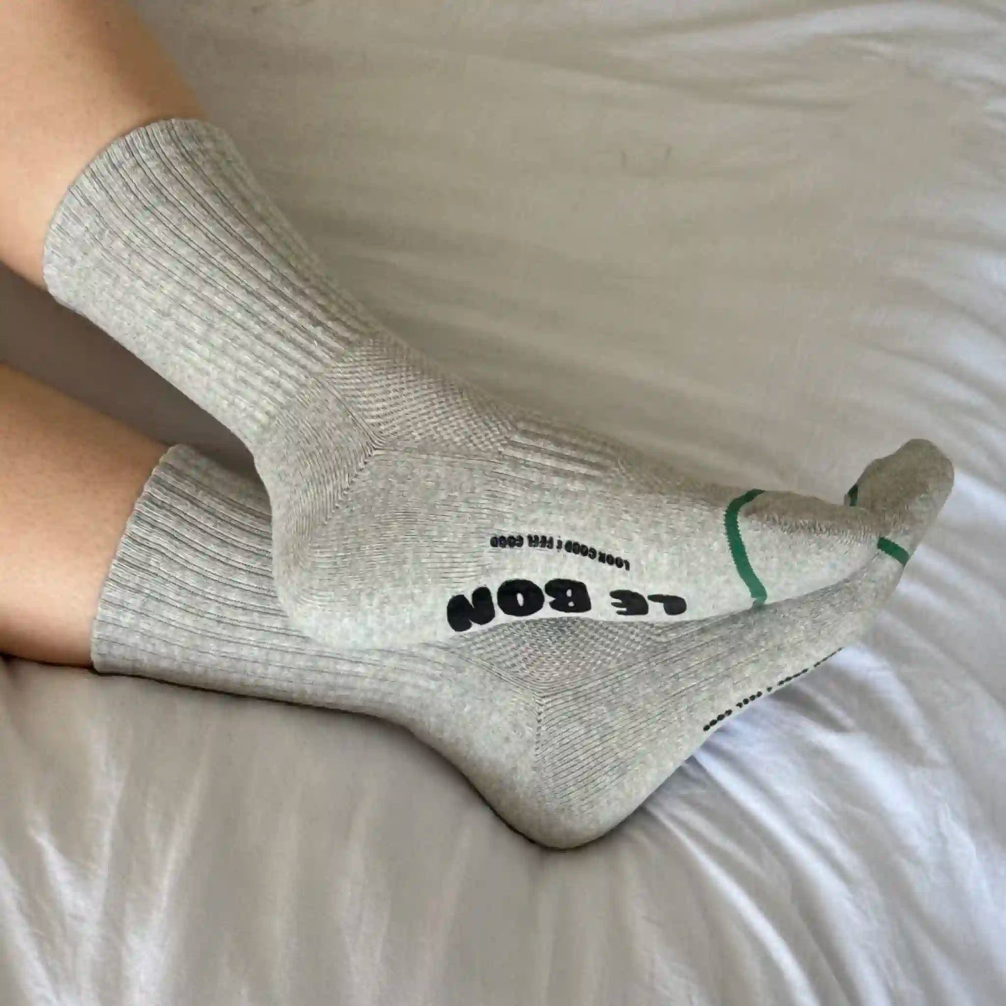 Gray socks with text on a light-colored surface