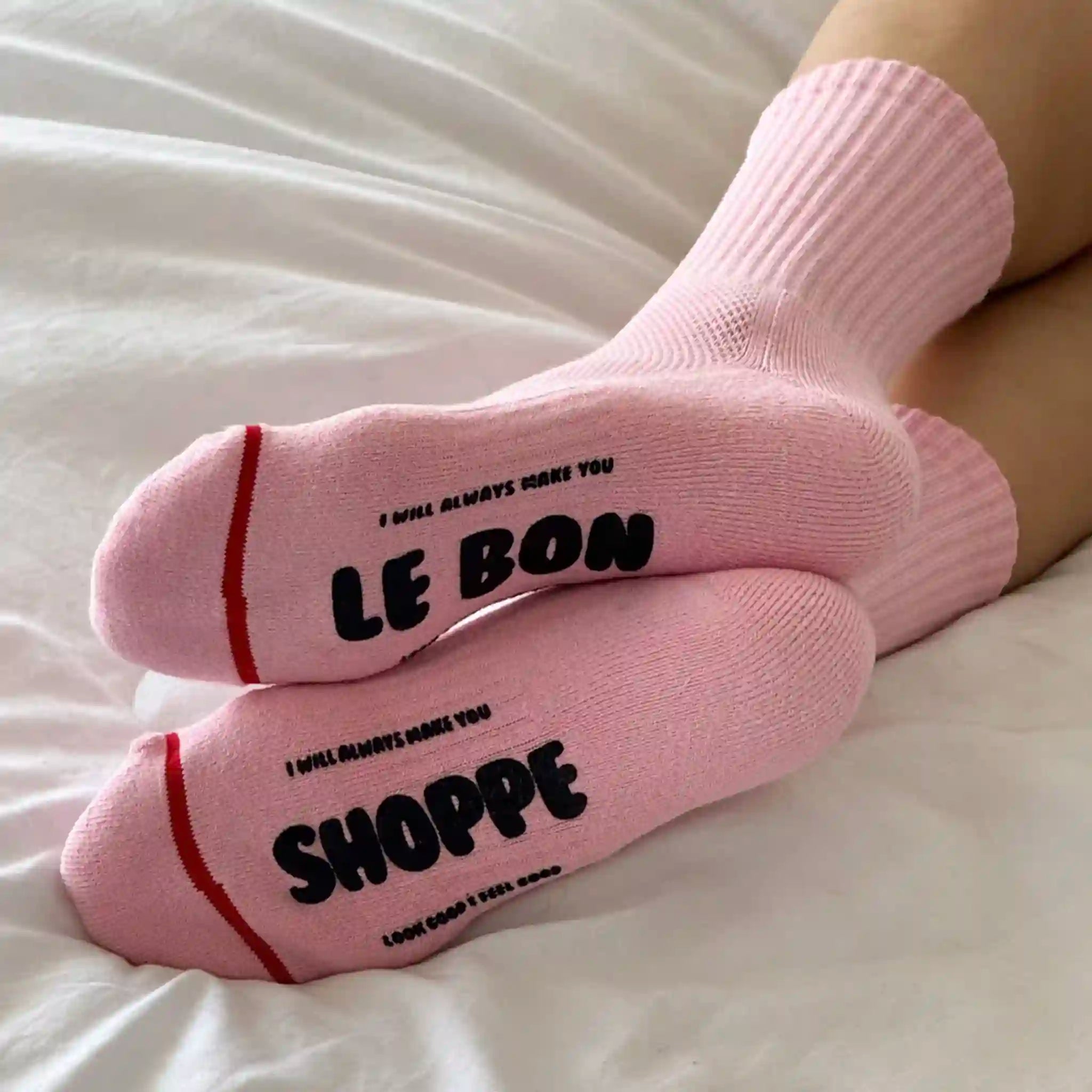 Pink socks with text on a white surface