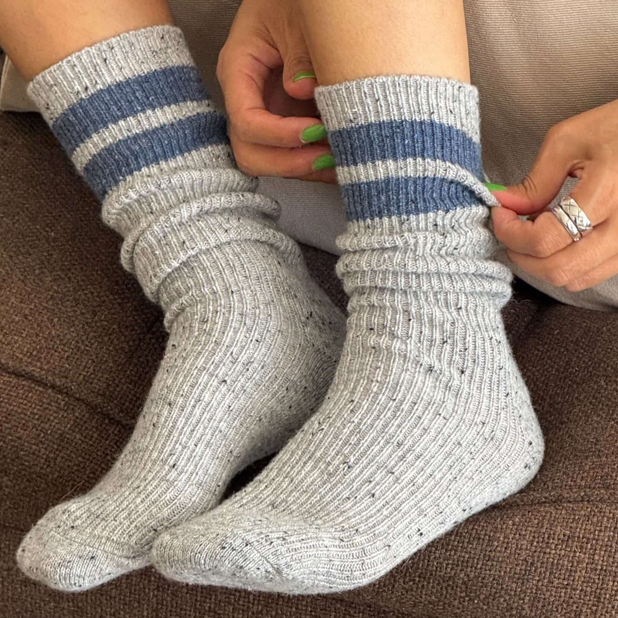 Le Bon Shoppe Snow Varsity Socks - Grey & Blue worn on cozy feet, showing ribbed texture and varsity striped design.