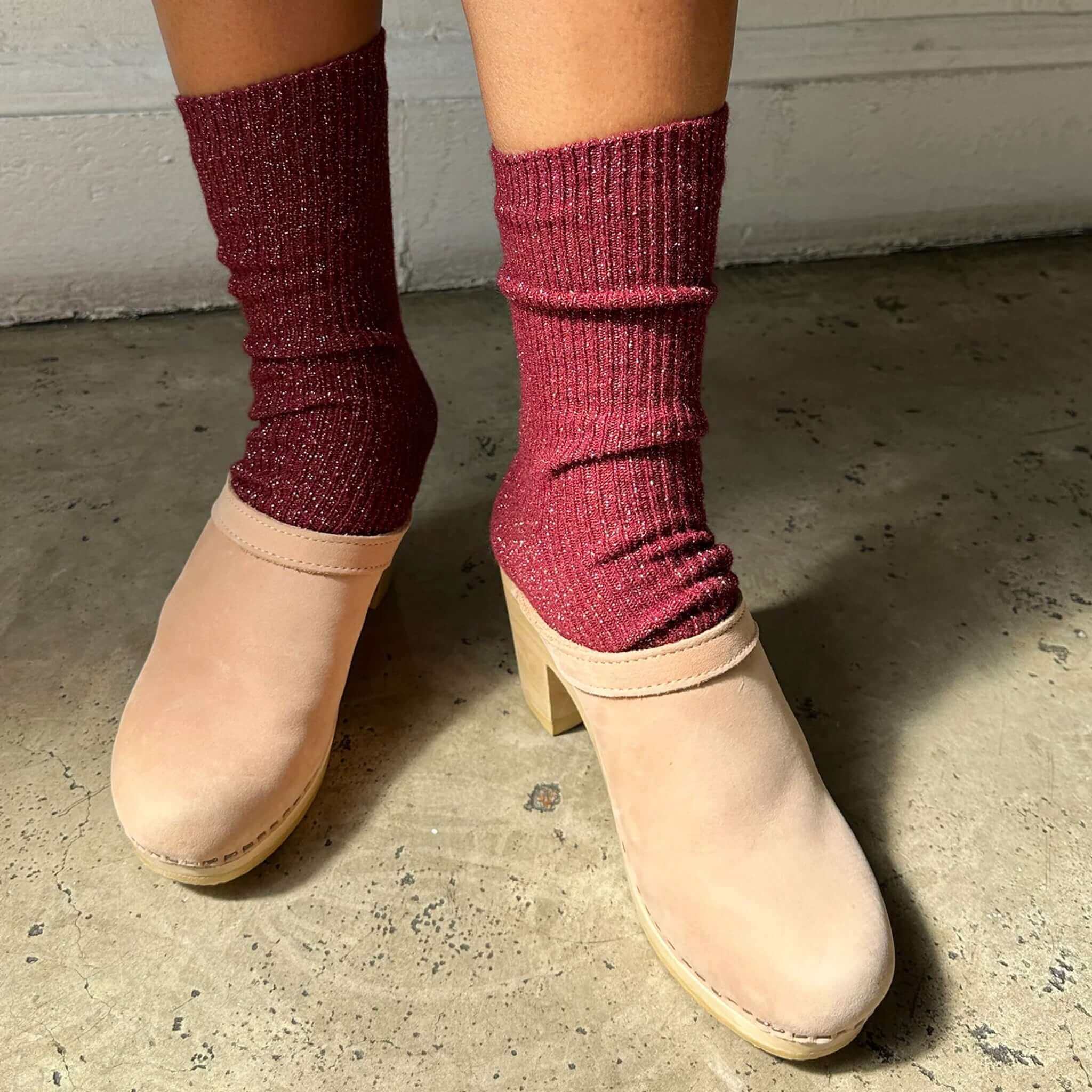 Le Bon Shoppe Winter Sparkle Socks - Wine styled with clogs on a textured floor.