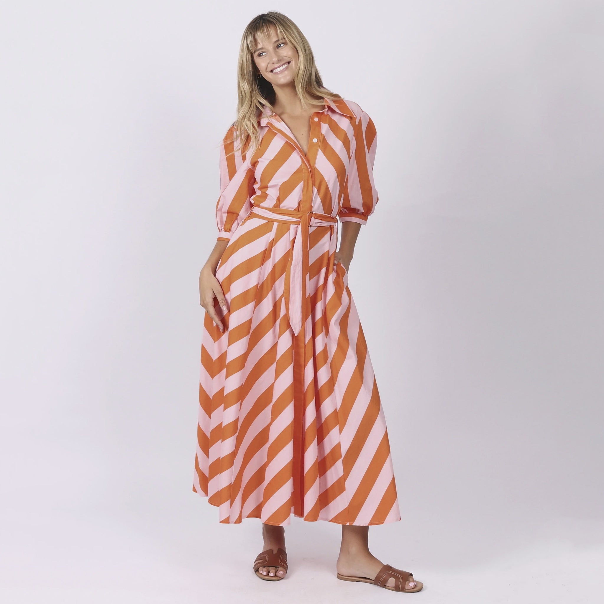 Woman wearing a striped dress on a white background